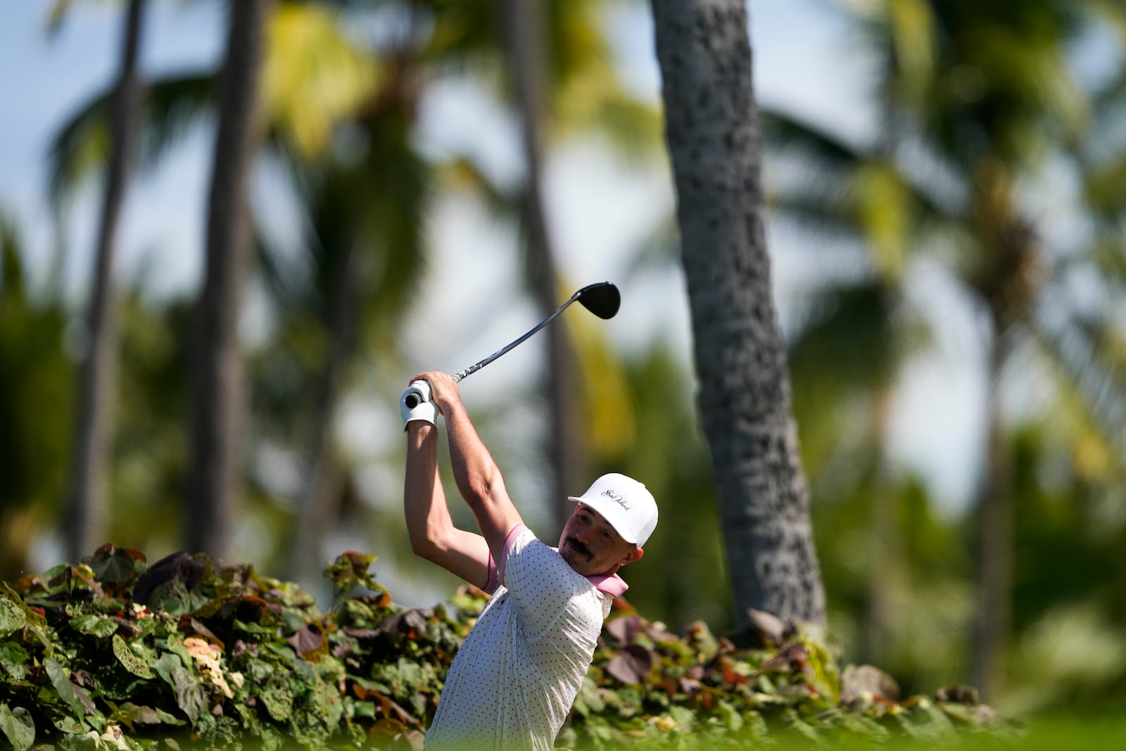 Paul Peterson hits on the 18th hole during the first round of the Sony Open golf event, Thursday, Jan. 9, 2025, at Waialae Country Club in Honolulu. (AP Photo/Matt York)