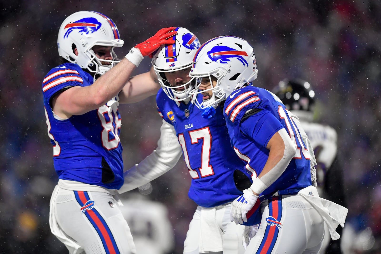 Buffalo Bills wide receiver Khalil Shakir (10) celebrates with quarterback Josh Allen (17) and tight end Dawson Knox (88) after a touchdown against the Baltimore Ravens during the second quarter of an NFL divisional playoff football game, Sunday, Jan. 19, 2025, in Orchard Park, N.Y. (AP Photo/Adrian Kraus)