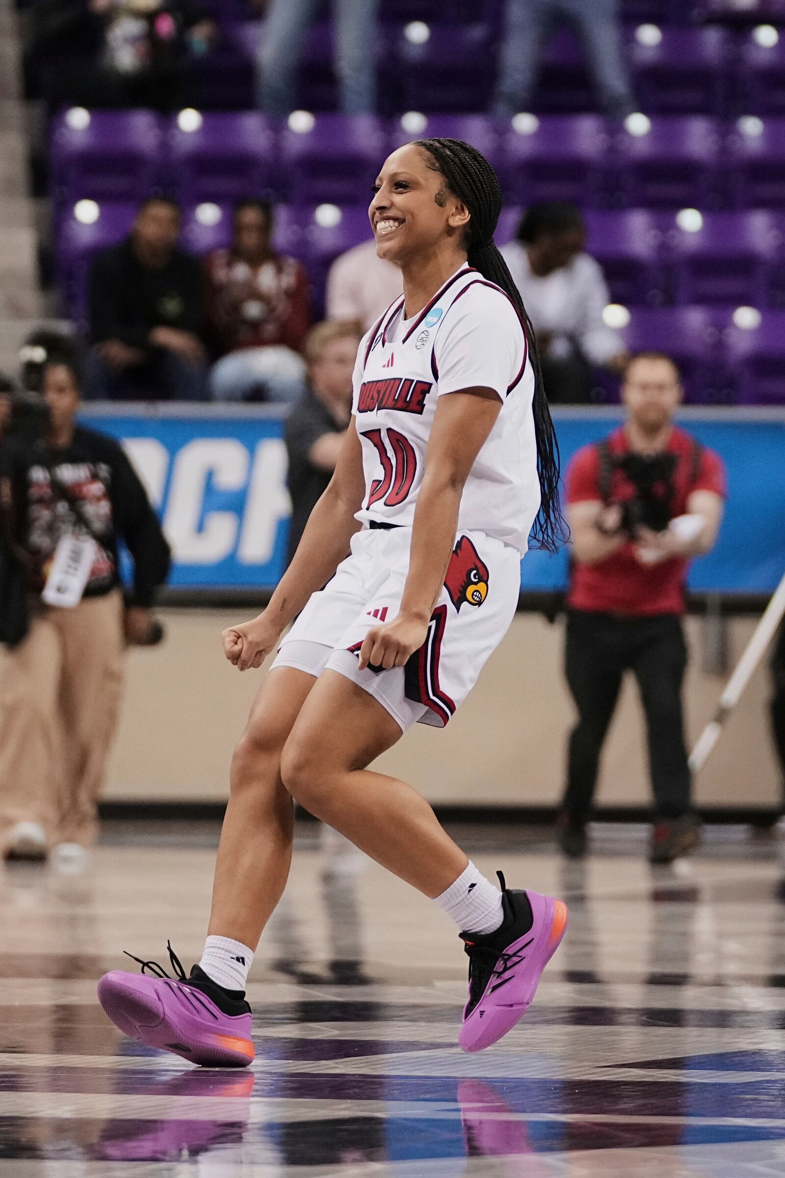 Louisville guard Jayda Curry runs onto the court while celebrating her team's win over Nebraska in the first round of the NCAA college basketball tournament in Fort Worth, Texas, Friday, March 21, 2025. (AP Photo/Tony Gutierrez)