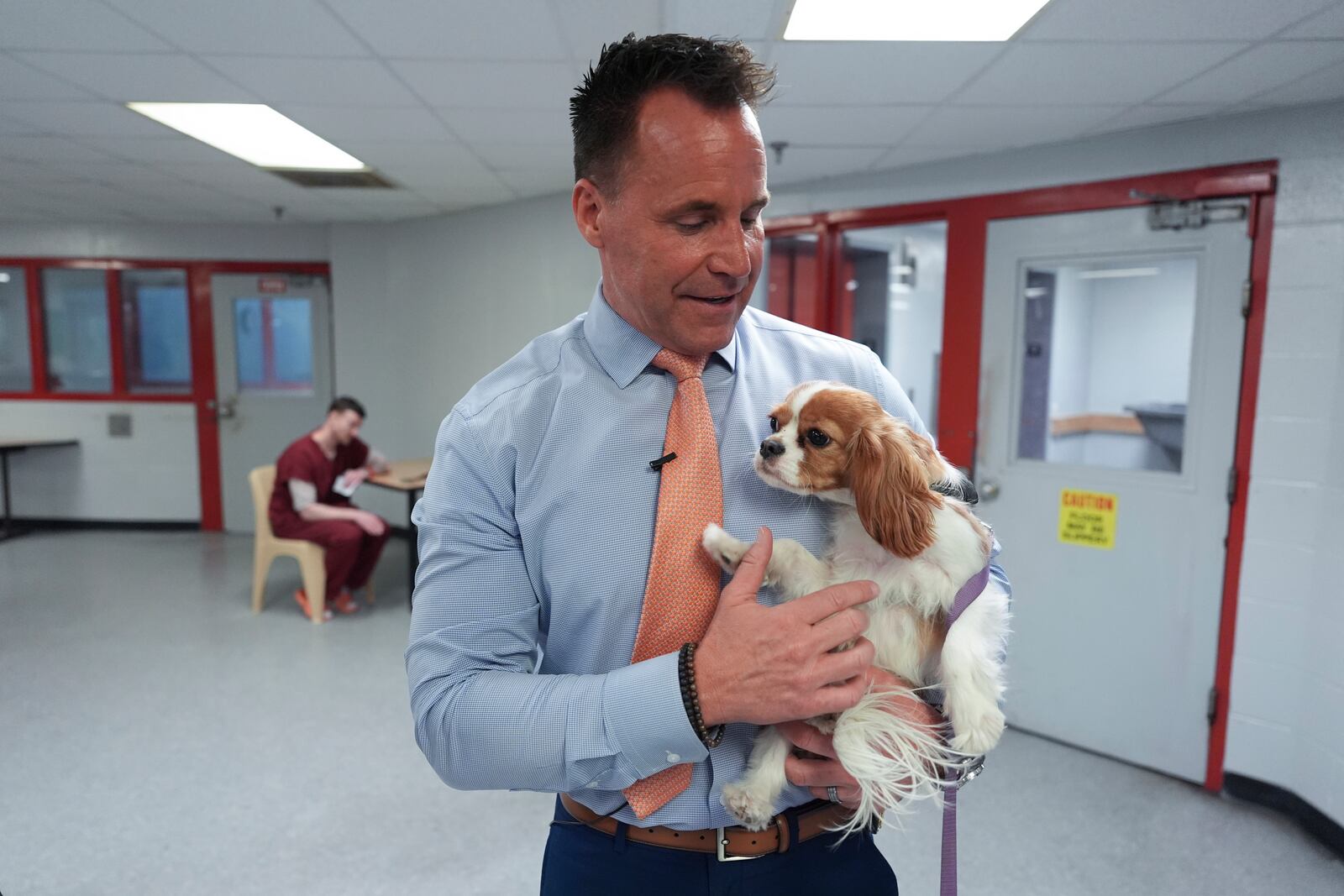 Genesee County Sheriff Chris Swanson holds Josie, an emotional support dog in the jail area, Jan. 28, 2025 in Flint, Mich. (AP Photo/Paul Sancya)