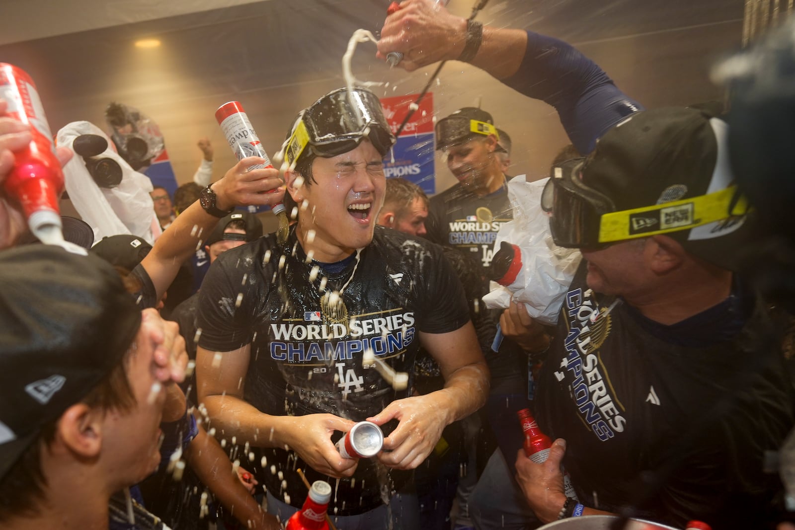 Los Angeles Dodgers' Shohei Ohtani celebrates in the locker room after their win against the New York Yankees in Game 5 to win the baseball World Series, Thursday, Oct. 31, 2024, in New York. (AP Photo/Ashley Landis)