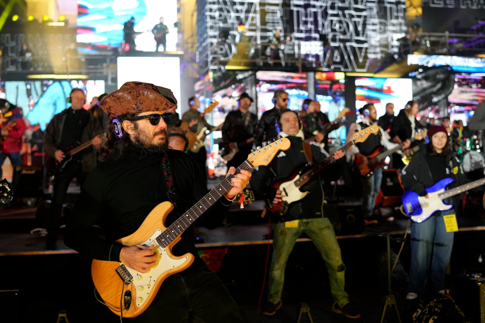 Musicians play on the stage during the concert for freedom for the 35th anniversary of the fall of the Berlin Wall, at the Brandenburg Gate in Berlin, Germany, Saturday, Nov. 9, 2024. (AP Photo/Ebrahim Noroozi)