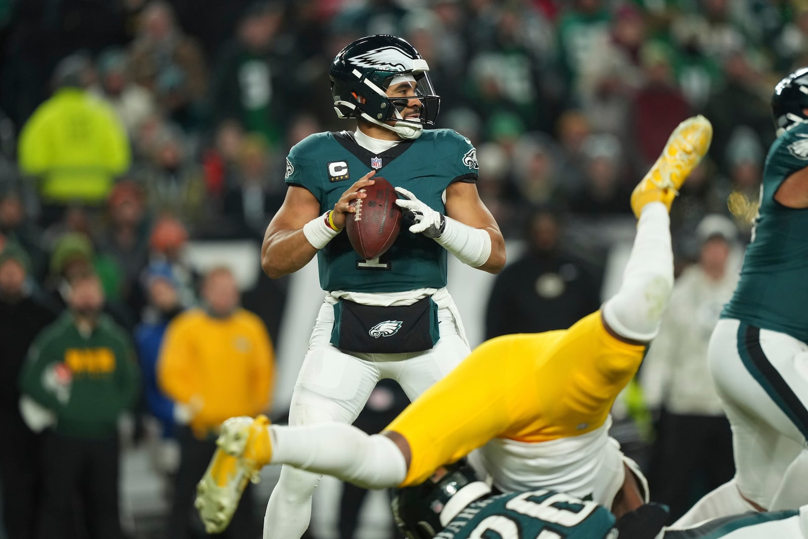 Philadelphia Eagles quarterback Jalen Hurts (1) looks to pass during the second half of an NFL wild-card playoff football game against the Green Bay Packers on Sunday, Jan. 12, 2025, in Philadelphia. (AP Photo/Matt Slocum)