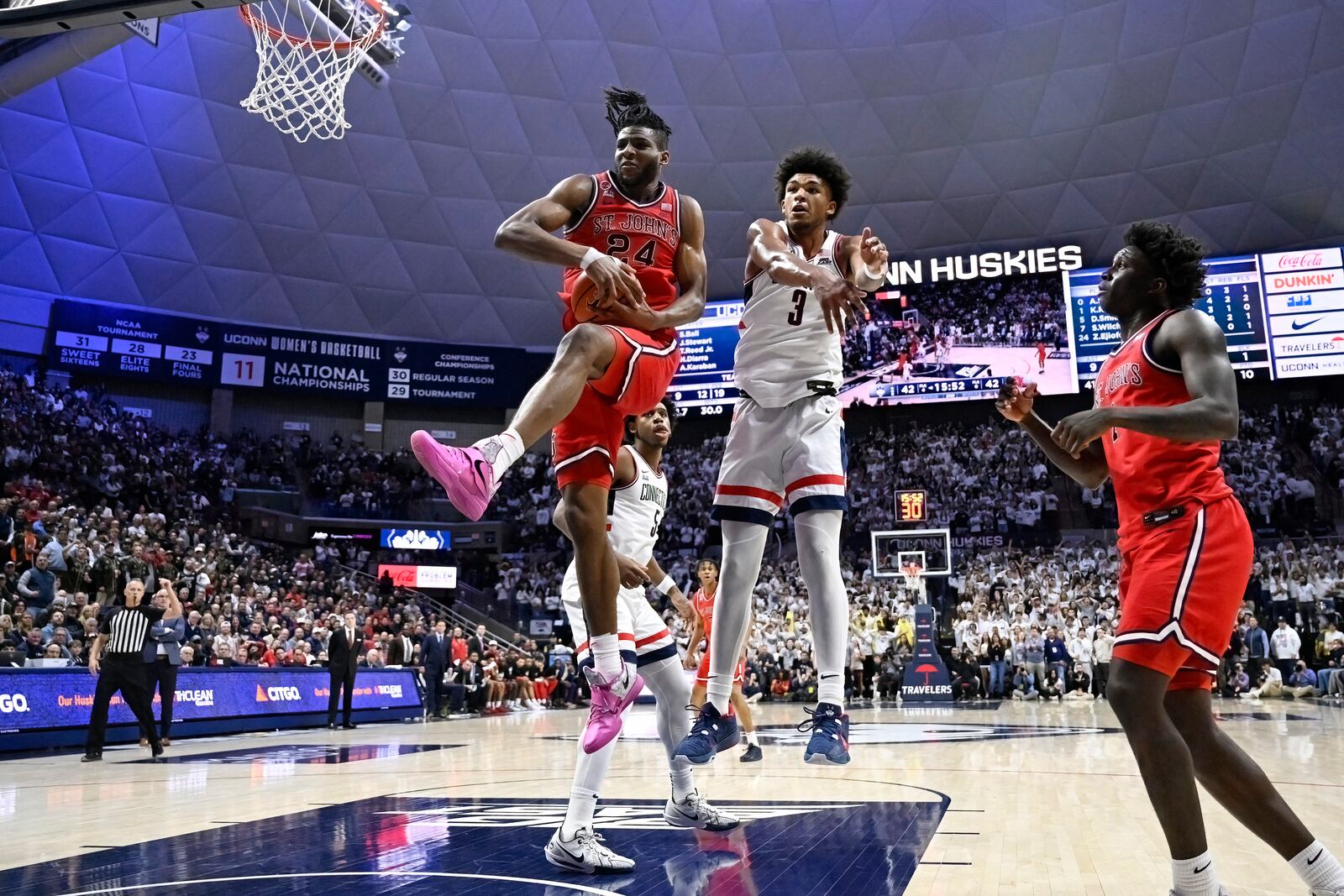 St. John's forward Zuby Ejiofor (24) grabs a rebound against UConn forward Jaylin Stewart (3) in the second half of an NCAA college basketball game, Friday, Feb. 7, 2025, in Storrs, Conn. (AP Photo/Jessica Hill)