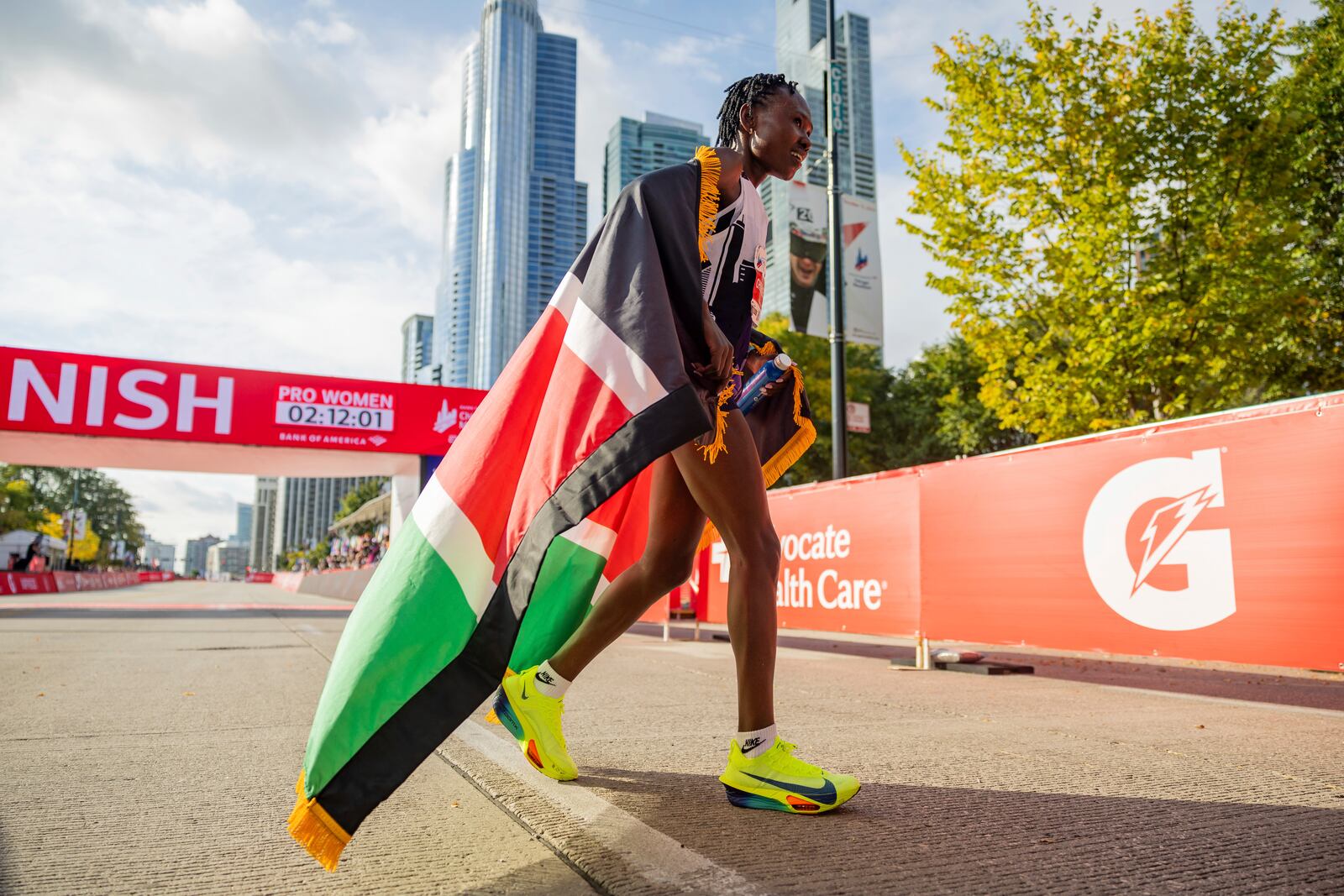 Ruth Chepngetich, from Kenya, reacts after crossing the finish line of the Chicago Marathon to win the women's professional division and break the women's marathon world record in Grant Park on Sunday, Oct. 13, 2024. (Tess Crowley/Chicago Tribune via AP)