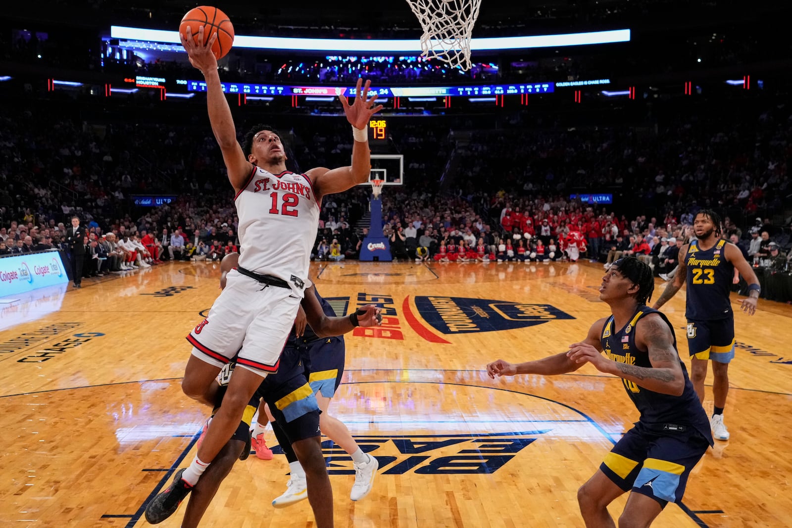 St. John's's RJ Luis Jr. (12) drives past Marquette's Damarius Owens (10) and Chase Ross during the first half of an NCAA college basketball game in the semifinals of the Big East tournament Friday, March 14, 2025, in New York. (AP Photo/Frank Franklin II)