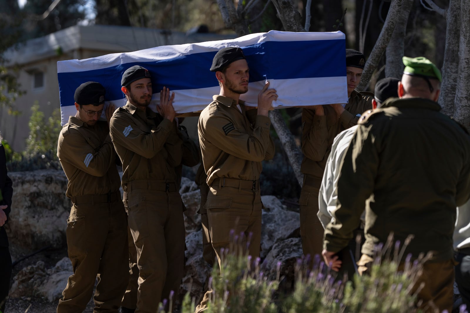 Israeli soldiers and relatives carry the flag-draped casket of 1st Sgt. Matityahu Ya'akov Perel, who was killed in combat in the Gaza Strip, during his funeral at the Mount Herzl military cemetery in Jerusalem, Israel, Thursday, Jan. 9, 2025. (AP Photo/Ohad Zwigenberg)