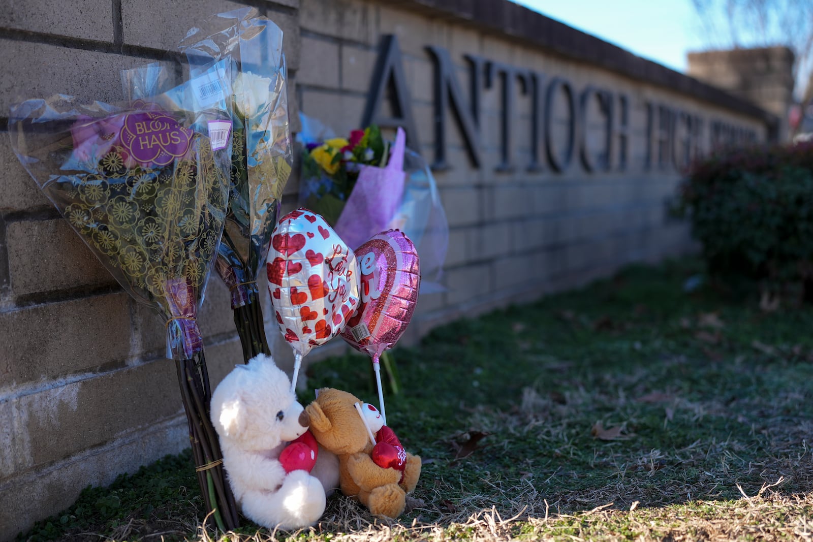 Flowers and stuffed animals are seen at a memorial for victims of a shooting at Antioch High School, Thursday, Jan. 23, 2025, in Nashville, Tenn. (AP Photo/George Walker IV)