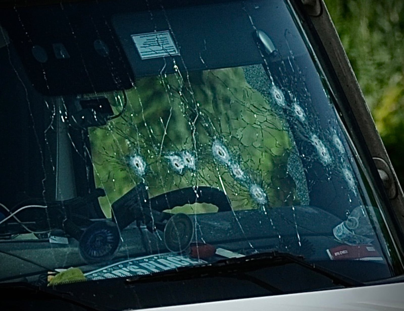 Bullet holes to the front windshield of a hijacked truck from London Ohio on Airport Access Rd., Wednesday August 2, 2023. MARSHALL GORBY\STAFF