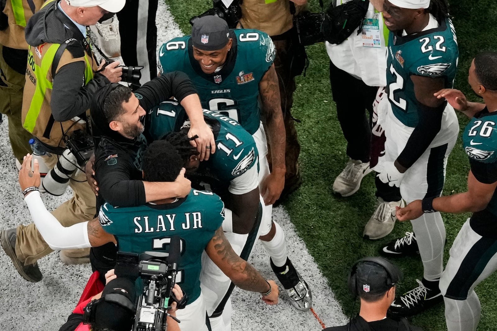 Philadelphia Eagles head coach Nick Sirianni, left, is hugged by wide receiver A.J. Brown (11) and cornerback Darius Slay Jr. (2) during the second half of the NFL Super Bowl 59 football game against the Kansas City Chiefs, Sunday, Feb. 9, 2025, in New Orleans. (AP Photo/Godofredo A. Vásquez)