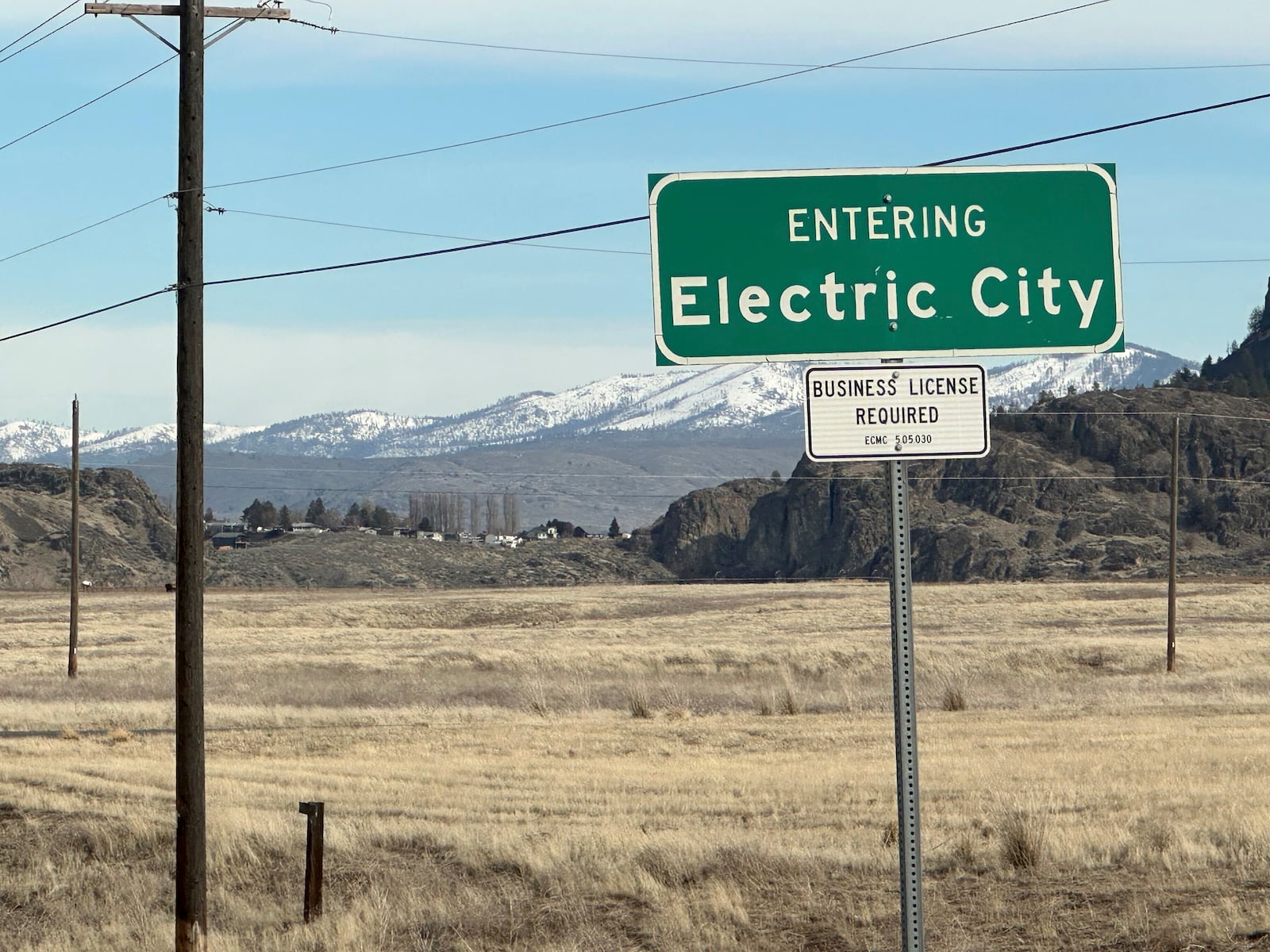 A road sign east of the Grand Coulee Dam, the largest hydropower generator in North America, welcomes travelers to Electric City, Washington, on Friday, Feb. 28, 2025. (AP Photo/Martha Bellisle)