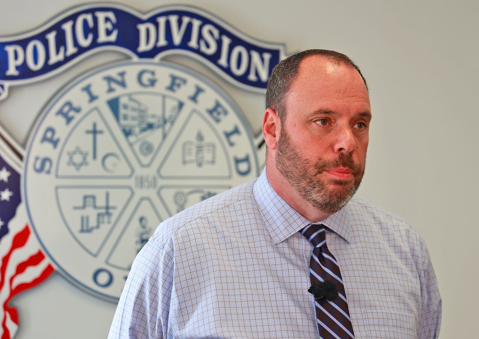 In a press conference at Springfield Police Headquarters Tuesday, May 23, 2023, Sgt. James Byron talks about Monday's car jacking and subsequent car chase that resulted in the arrest of one adult and three juveniles after a crash in Mad River Township. BILL LACKEY/STAFF