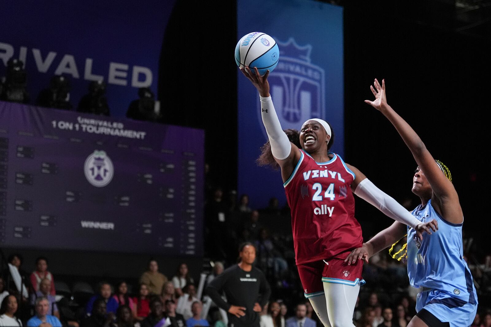 Arike Ogunbowale jumps to the basket over Aaliyah Edwards in their Unrivaled 1-on-1 basketball semifinal, Friday, Feb. 14, 2025, in Medley, Fla. (AP Photo/Rebecca Blackwell)