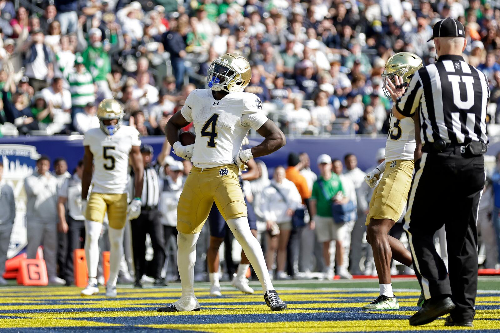 Notre Dame running back Jeremiyah Love (4) reacts after scoring a touchdown during the first half of an NCAA college football game against Navy Saturday, Oct. 26, 2024, in East Rutherford, N.J. (AP Photo/Adam Hunger)