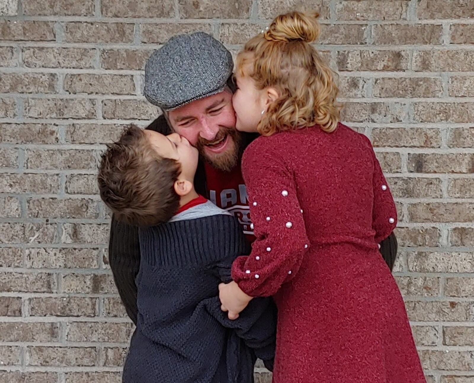 Andy Murphy, center, gets kisses from his son Andrew and daughter Kerrigan.