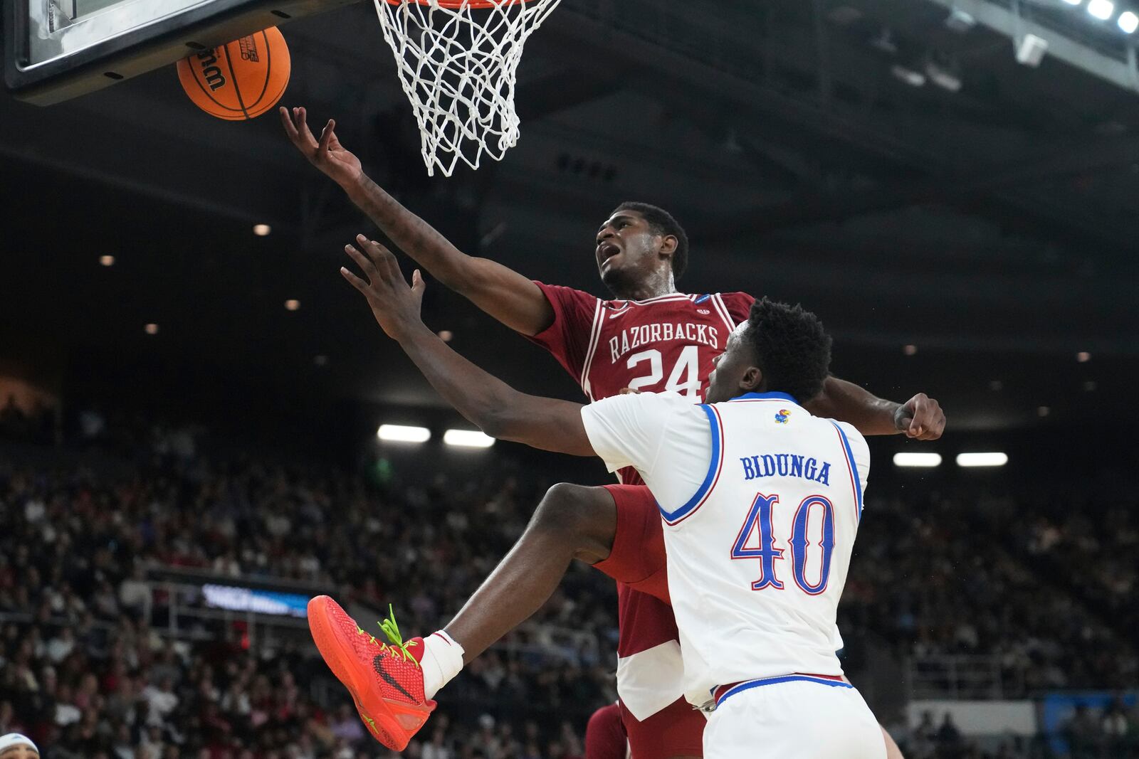 Arkansas forward Billy Richmond III (24) tries to grab a rebound against Kansas forward Flory Bidunga (40) during the first half in the first round of the NCAA college basketball tournament, Thursday, March 20, 2025, in Providence, R.I. (AP Photo/Charles Krupa)