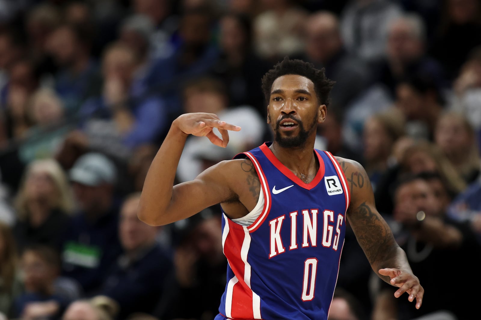 Sacramento Kings guard Malik Monk (0) celebrates after scoring a three-point basket during the second half of an NBA basketball game against the Minnesota Timberwolves, Wednesday, Nov. 27, 2024, in Minneapolis. (AP Photo/Ellen Schmidt)