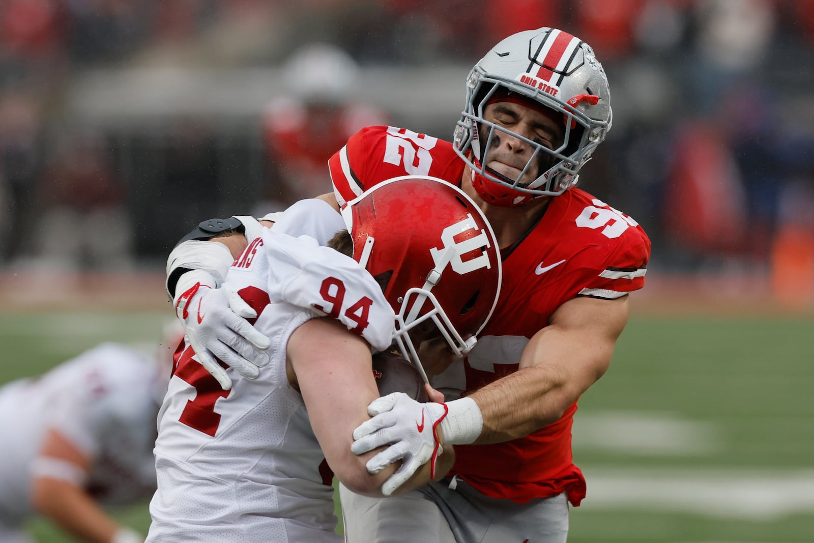 Ohio State defensive lineman Caden Curry, right, tackles Indiana punter James Evans after a mishandled snap during the first half of an NCAA college football game Saturday, Nov. 23, 2024, in Columbus, Ohio. (AP Photo/Jay LaPrete)