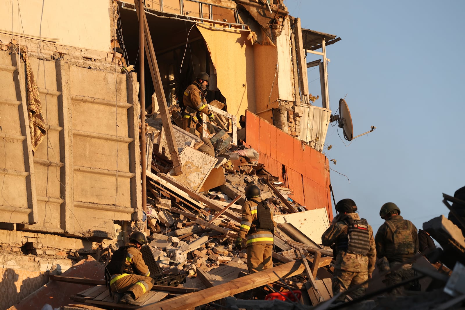 Rescue workers clear the rubble of a residential building destroyed by a Russian airstrike in Zaporizhzhia, Ukraine, Thursday, Nov. 7, 2024. (AP Photo/Kateryna Klochko)