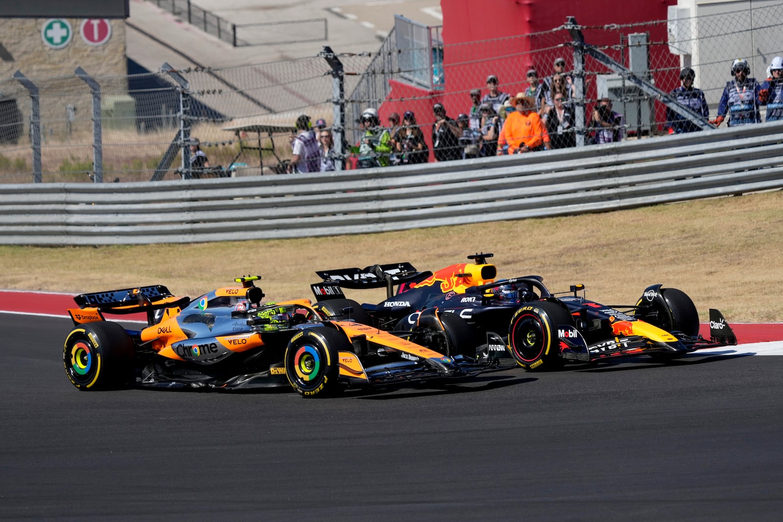 McLaren driver Lando Norris, left, of Britain, and Red Bull driver Max Verstappen, right, of the Netherlands, race through a turn during the U.S. Grand Prix auto race at Circuit of the Americas, Sunday, Oct. 20, 2024, in Austin, Texas. (AP Photo/Eric Gay)