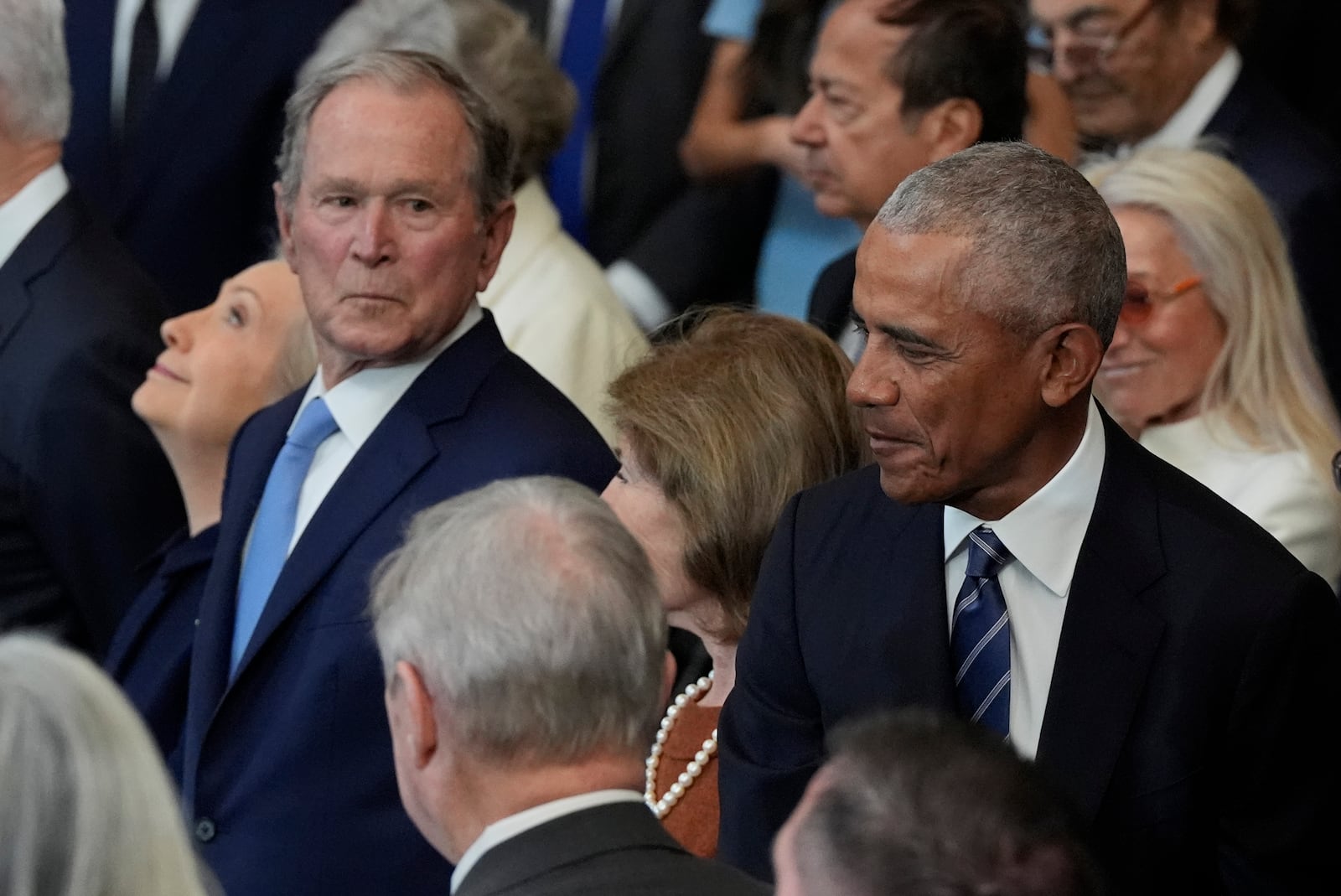 Former President George W. Bush, Laura Bush and former President Barack Obama arrive before the 60th Presidential Inauguration in the Rotunda of the U.S. Capitol in Washington, Monday, Jan. 20, 2025. (AP Photo/Julia Demaree Nikhinson, Pool)