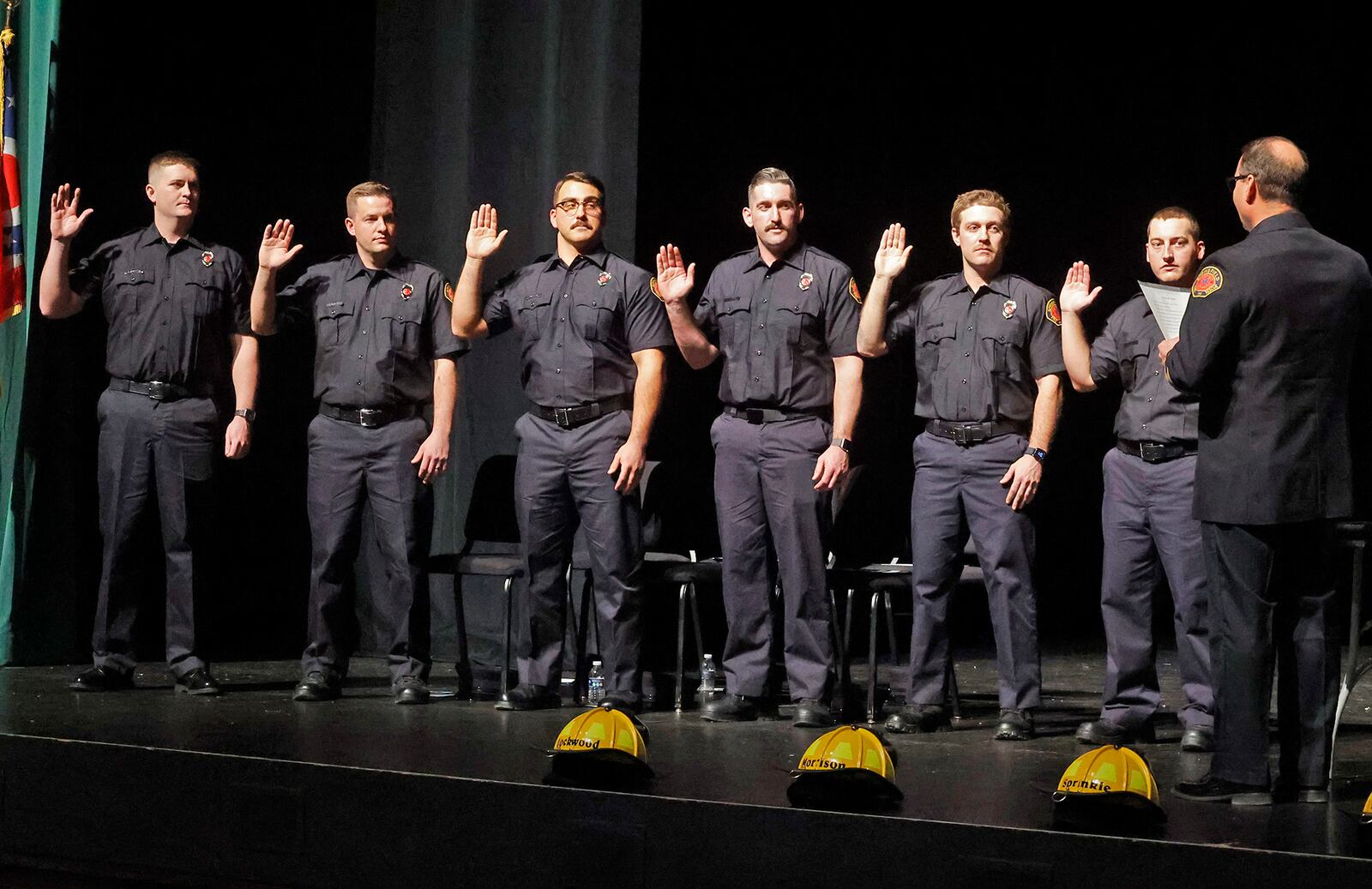 Six new firefighters are sworn in by Springfield Fire Chief Jacob King Friday, Jan. 5, 2024 during a Fire Academy Graduation and Awards Ceremony at the Clark State Performing Arts Center. The firefighter are, from left, Zachary Sprinkle, Kevin Lockwood, Levi Morrison, Zachary Ramey, Anthony DeCarlo and Cole Schlereth. BILL LACKEY/STAFF