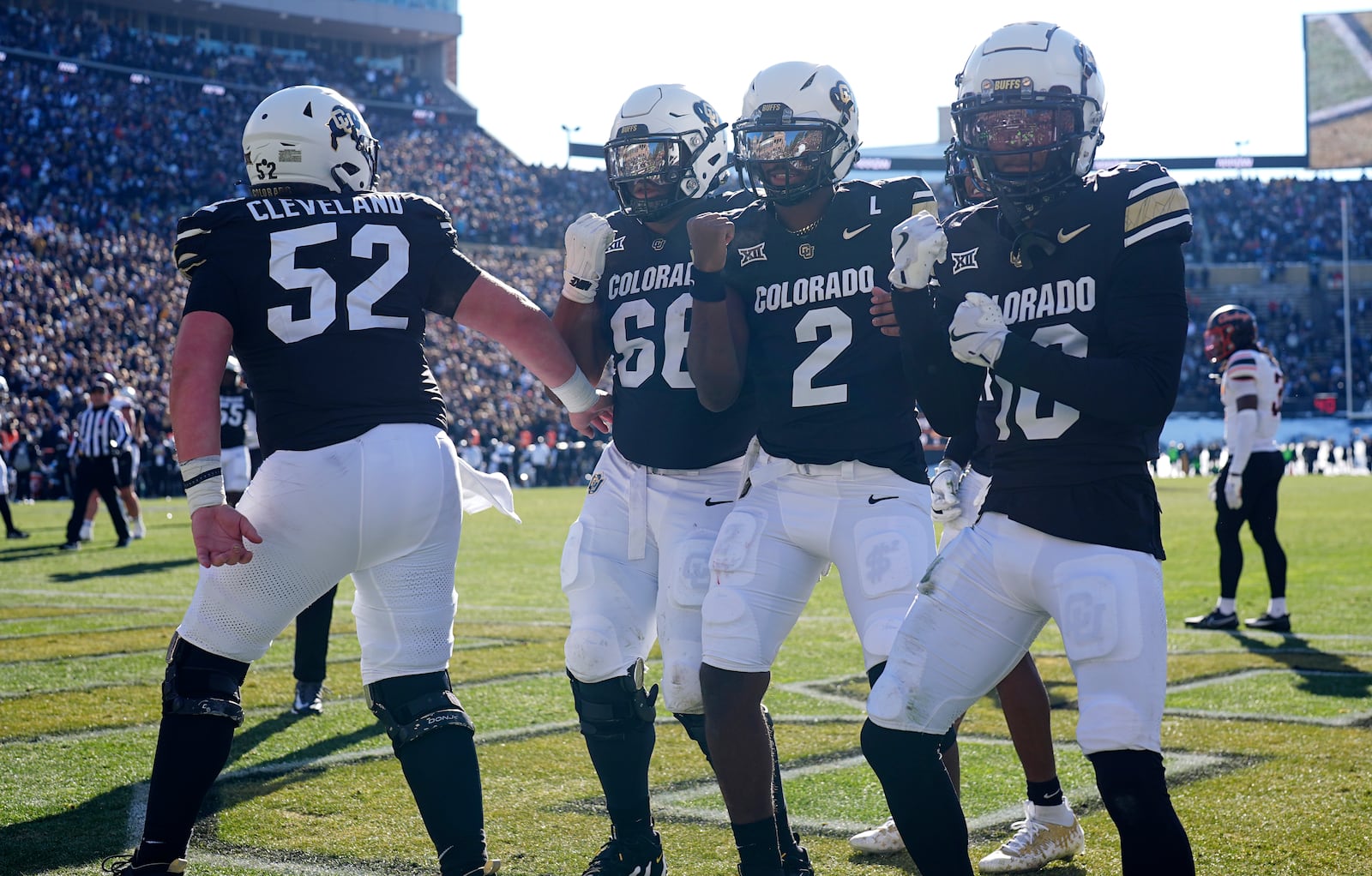 From left; Colorado offensive lineman Cash Cleveland celebrates with offensive lineman Justin Mayers after quarterback Shedeur Sanders tossed a touchdown pass to wide receiver LaJohntay Wester in the first half of an NCAA college football game against Oklahoma State Friday, Nov. 29, 2024, in Boulder, Colo. (AP Photo/David Zalubowski)