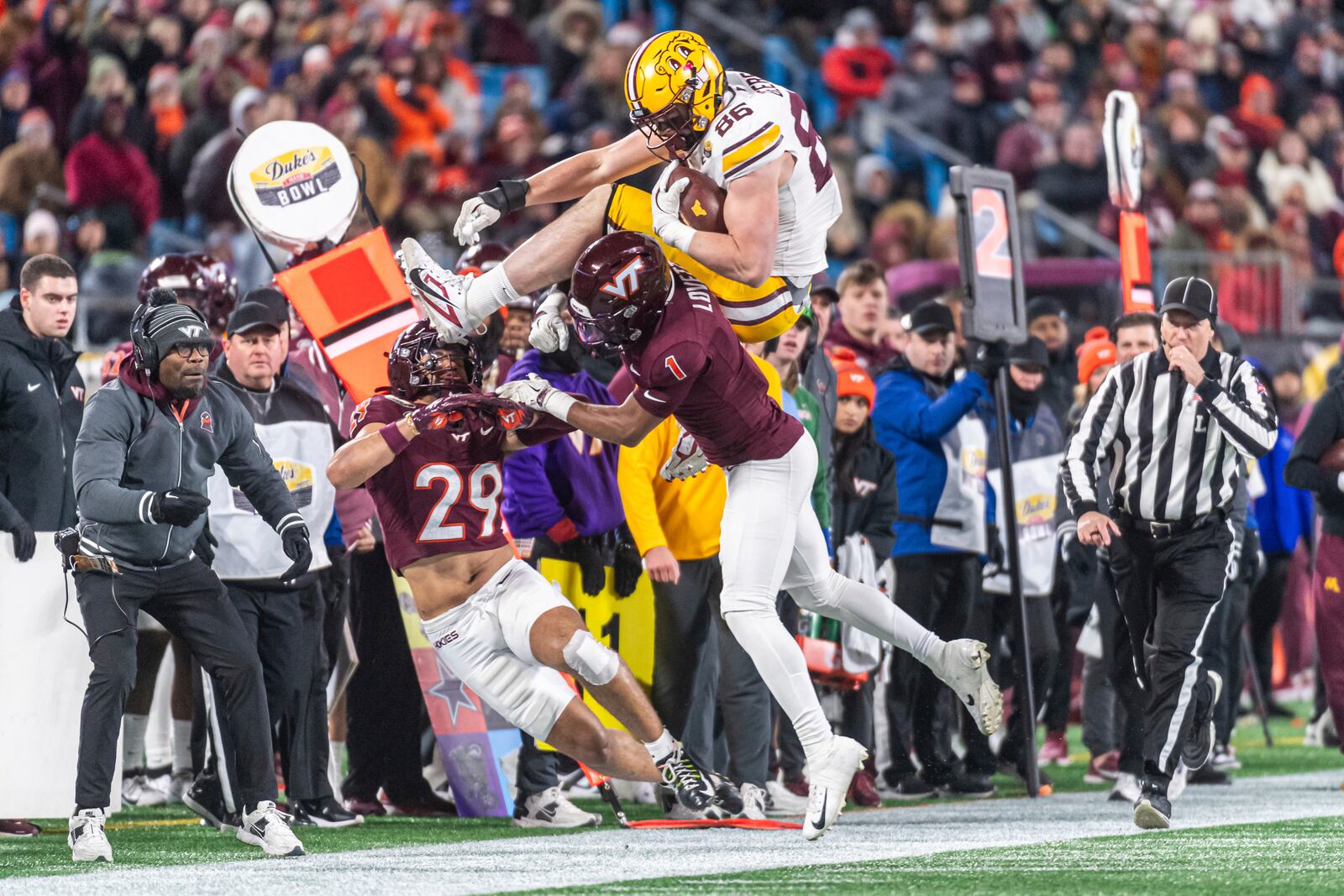 Minnesota tight end Jameson Geers (86) goes over Virginia Tech cornerback Dante Lovett (1) during the first half of the Duke's Mayo Bowl NCAA college football game Friday, Jan. 3, 2025, in Blacksburg, Va. (AP Photo/Robert Simmons)