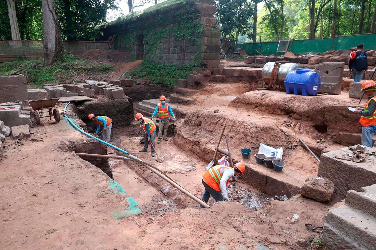 This handout photo provided by Apsaras National Authority shows archaeologists working at unearthing a centuries-old sandstone statue at Angkor Thom in Cambodia, Oct. 24, 2024. (Phouk Chea/Apsaras National Authority via AP)