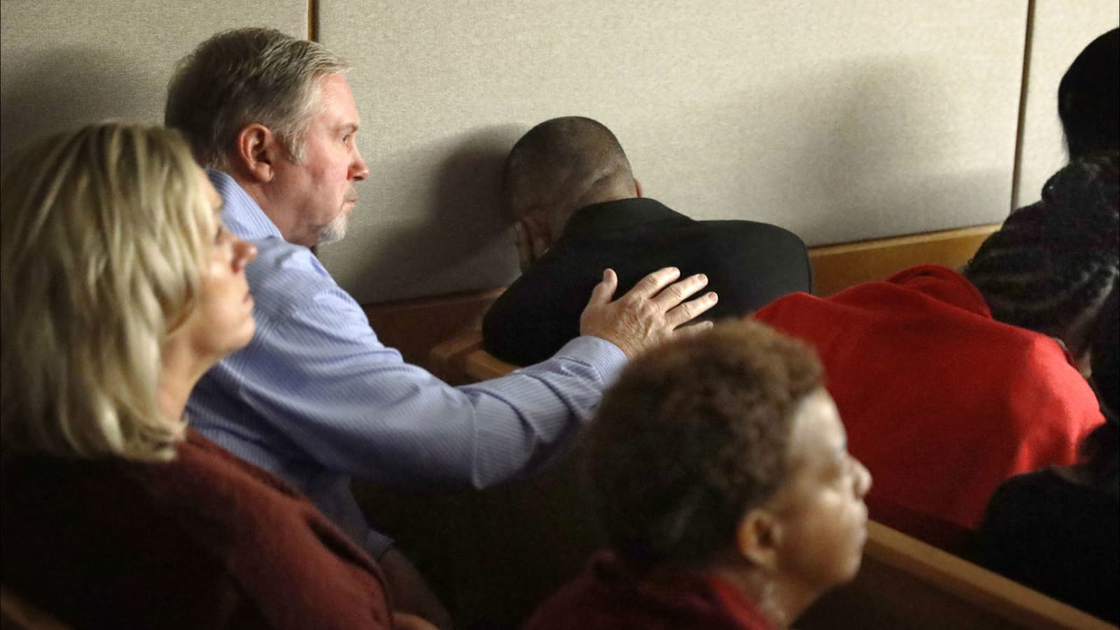 Bertrum Jean, father of Botham Jean, hides his eyes and covers his ears as footage of his son's death is played in court Wednesday, Sept. 25, 2019. Ex-Dallas police officer Amber Guyger is accused of killing Jean last year in an apartment mix-up.