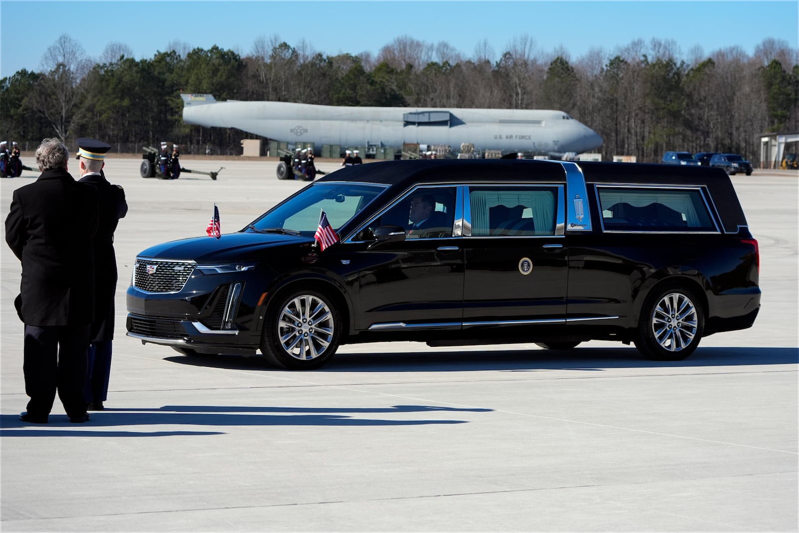 The hearse carrying the flag-draped casket of former President Jimmy Carter arrives at Dobbins Air Reserve Base in Marietta, Ga., Tuesday, Jan. 7, 2025. Carter died Dec. 29 at the age of 100. (AP Photo/Alex Brandon, Pool)