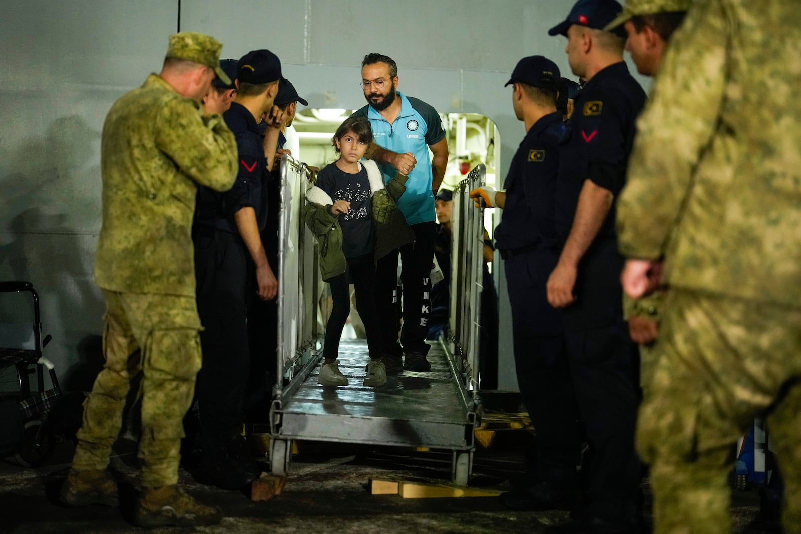 People, mostly Turkish nationals, disembark from Turkish TCG Sancaktar military ship after being evacuated from Lebanon's capital Beirut to Turkey, in Mersin port, southern Turkey, early Friday, Oct. 11, 2024. (AP Photo/Emrah Gurel)