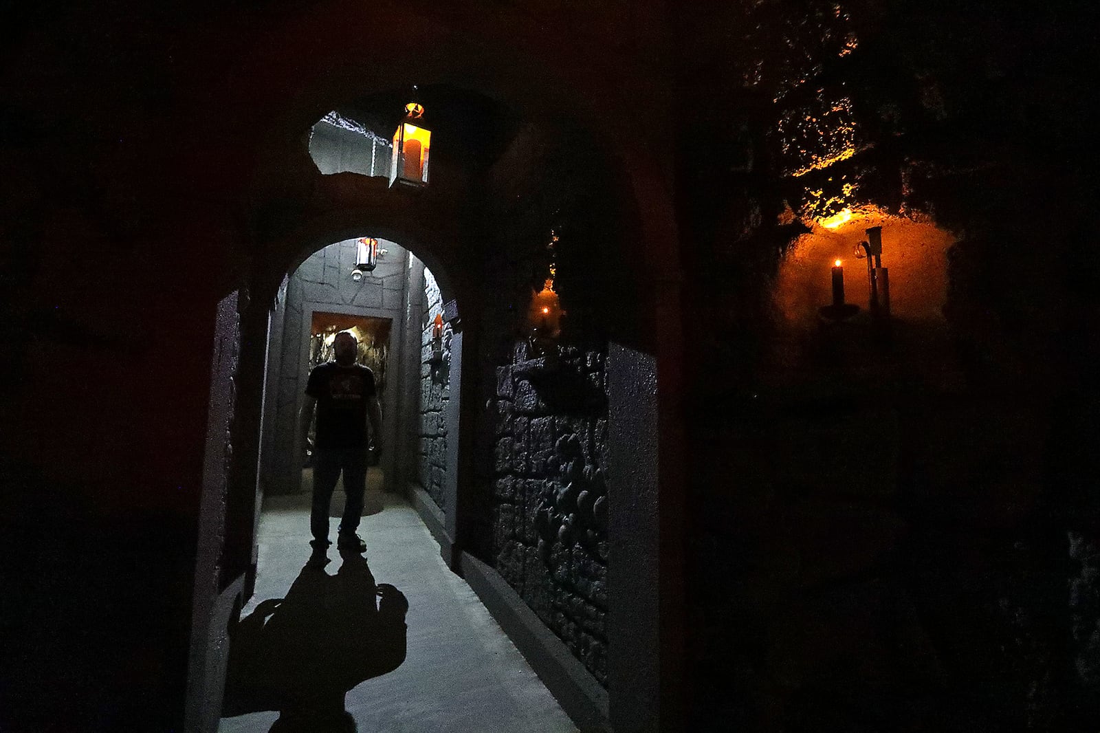 A worker stands in a doorway of the wine cellar at Face Your Fears Hotel of Terror in Springfield. BILL LACKEY/STAFF