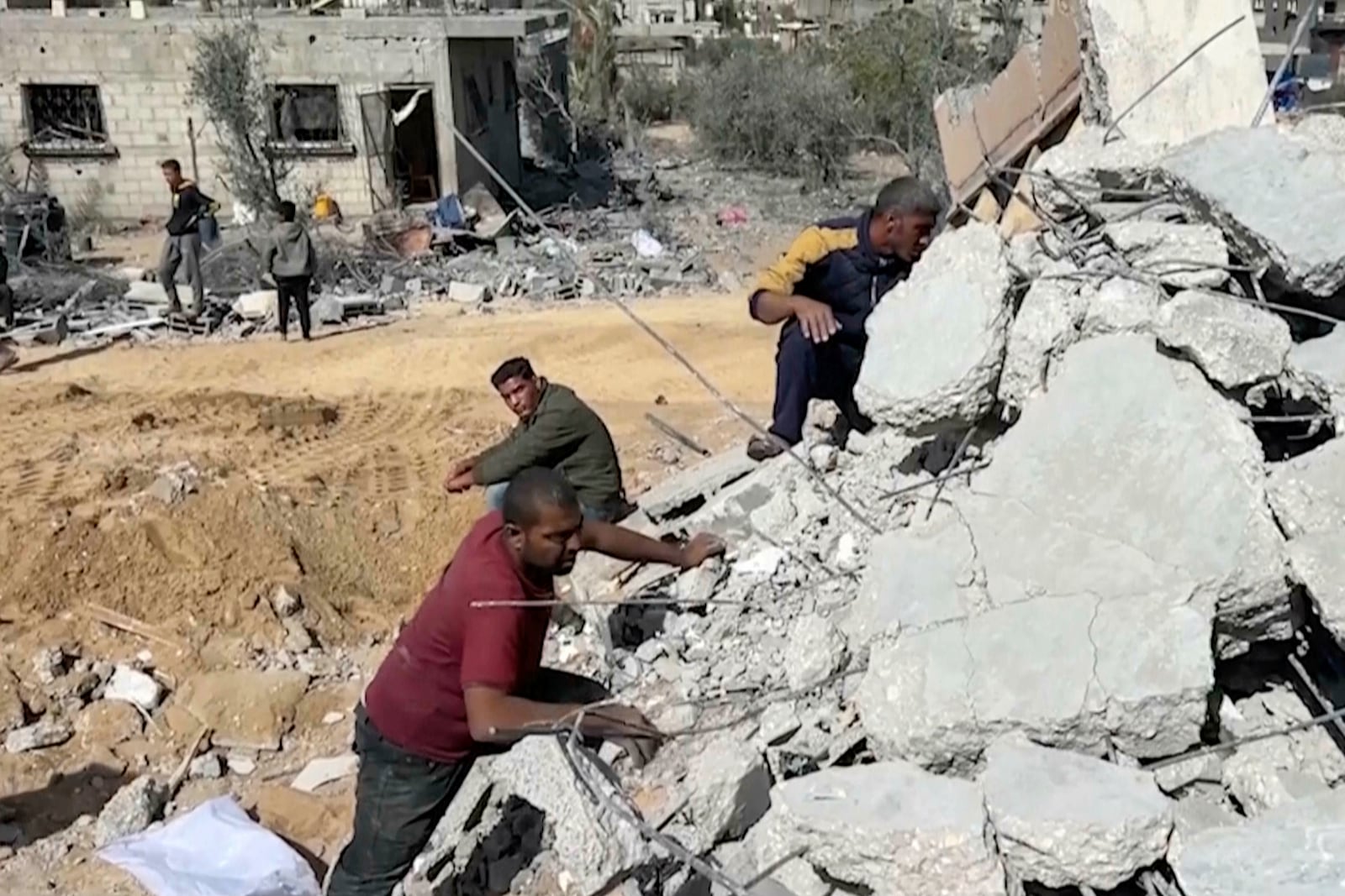 Palestinians sift through the rubble of a building destroyed by Israeli airstrikes in the city of Khan Younis, southern Gaza Strip, Friday, Oct. 25, 2024. (AP Photo)