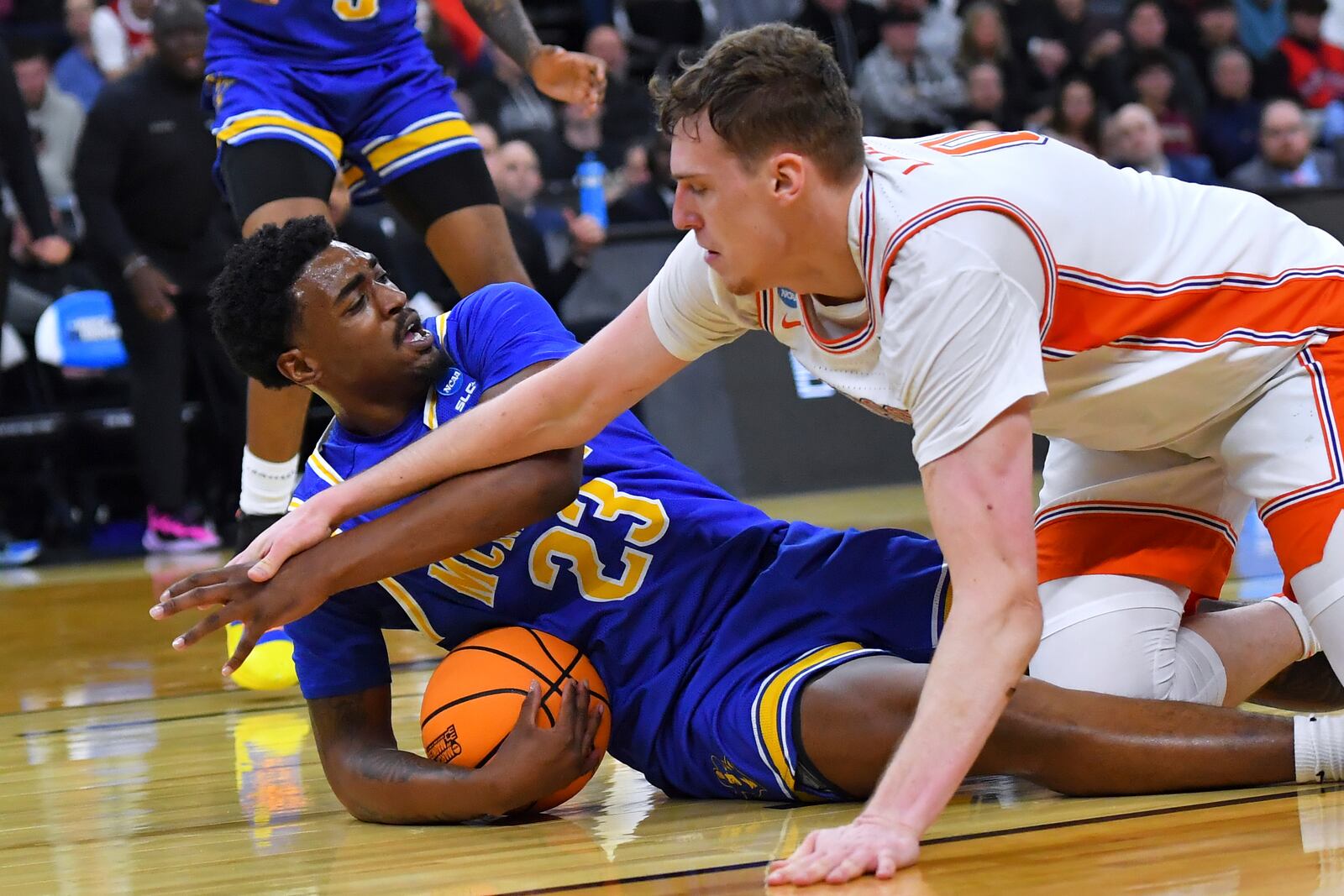 McNeese State guard Brandon Murray (23) grabs the loose ball against Clemson center Viktor Lakhin (0) during the first half in the first round of the NCAA college basketball tournament, Thursday, March 20, 2025, in Providence, R.I. (AP Photo/Steven Senne)