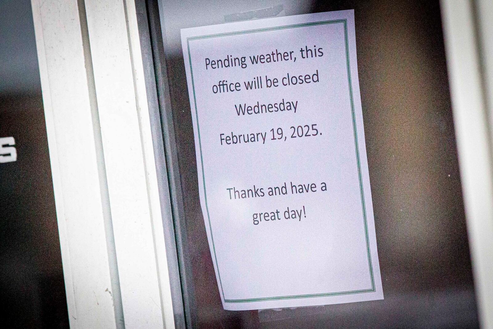 A store in downtown provides signage about potential winter weather impacting their hours in Florence, Ala., Wednesday, Feb. 19, 2025. (Dan Busey/The TimesDaily via AP)