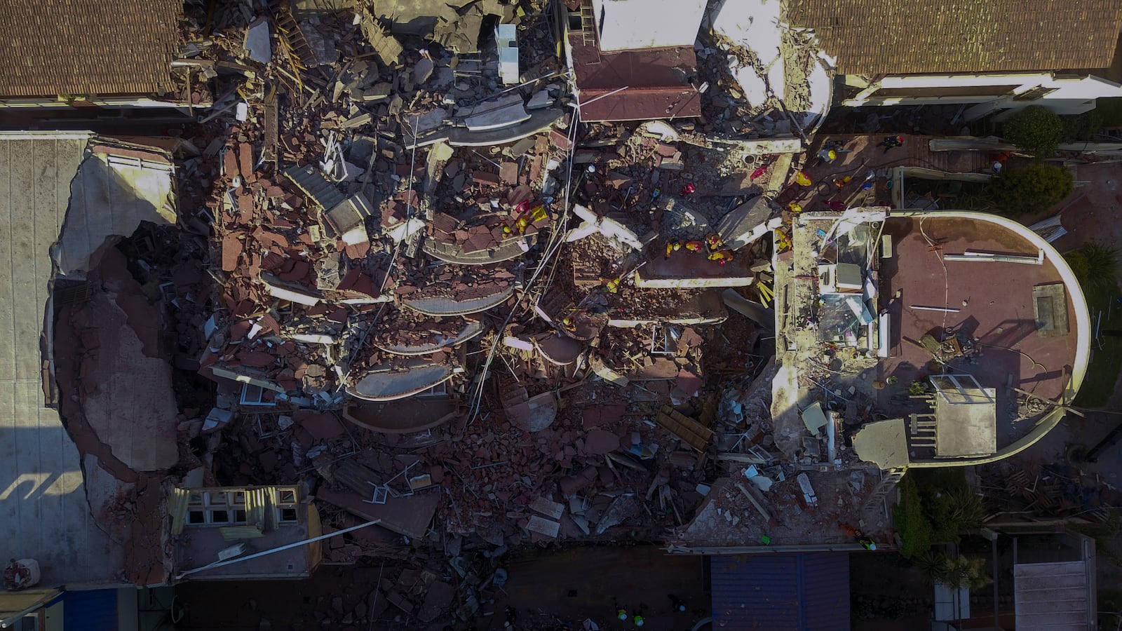 Firefighters and rescuers work to find survivors in the debris of the partially collapsed Dubrovnik Hotel, in Villa Gesell, Argentina, Tuesday, Oct. 29, 2024. (AP Photo/Christian Heit)