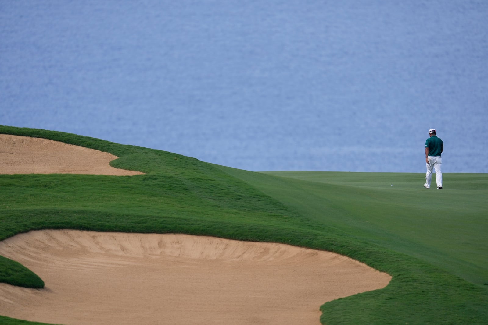 Hideki Matsuyama, of Japan, walks to his ball on the 12th hole during the third round of The Sentry golf event, Saturday, Jan. 4, 2025, at Kapalua Plantation Course in Kapalua, Hawaii. (AP Photo/Matt York)