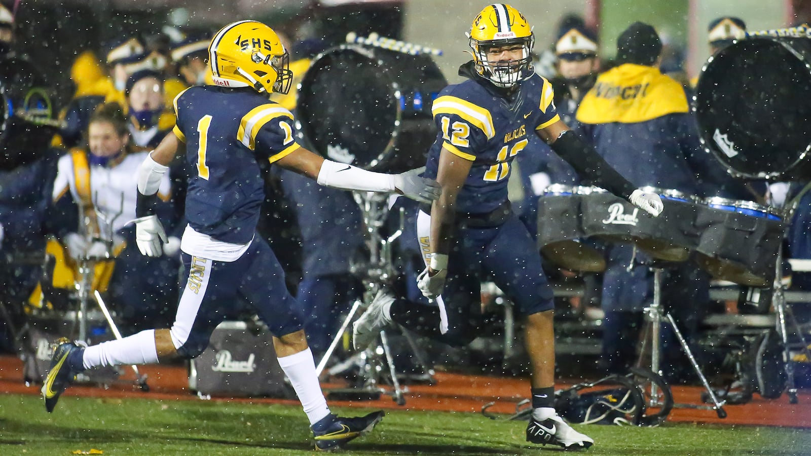 Springfield High School junior defensive back Tawfig Jabbar and junior defensive back Tyron Barnes celebrated after Jabbar blocked a punt and returned it for a touchdown during their game against Findlay on Friday night at AcuSport Stadium in Bellefontaine. The Wildcats won 13-0. CONTRIBUTED PHOTO BY MICHAEL COOPER