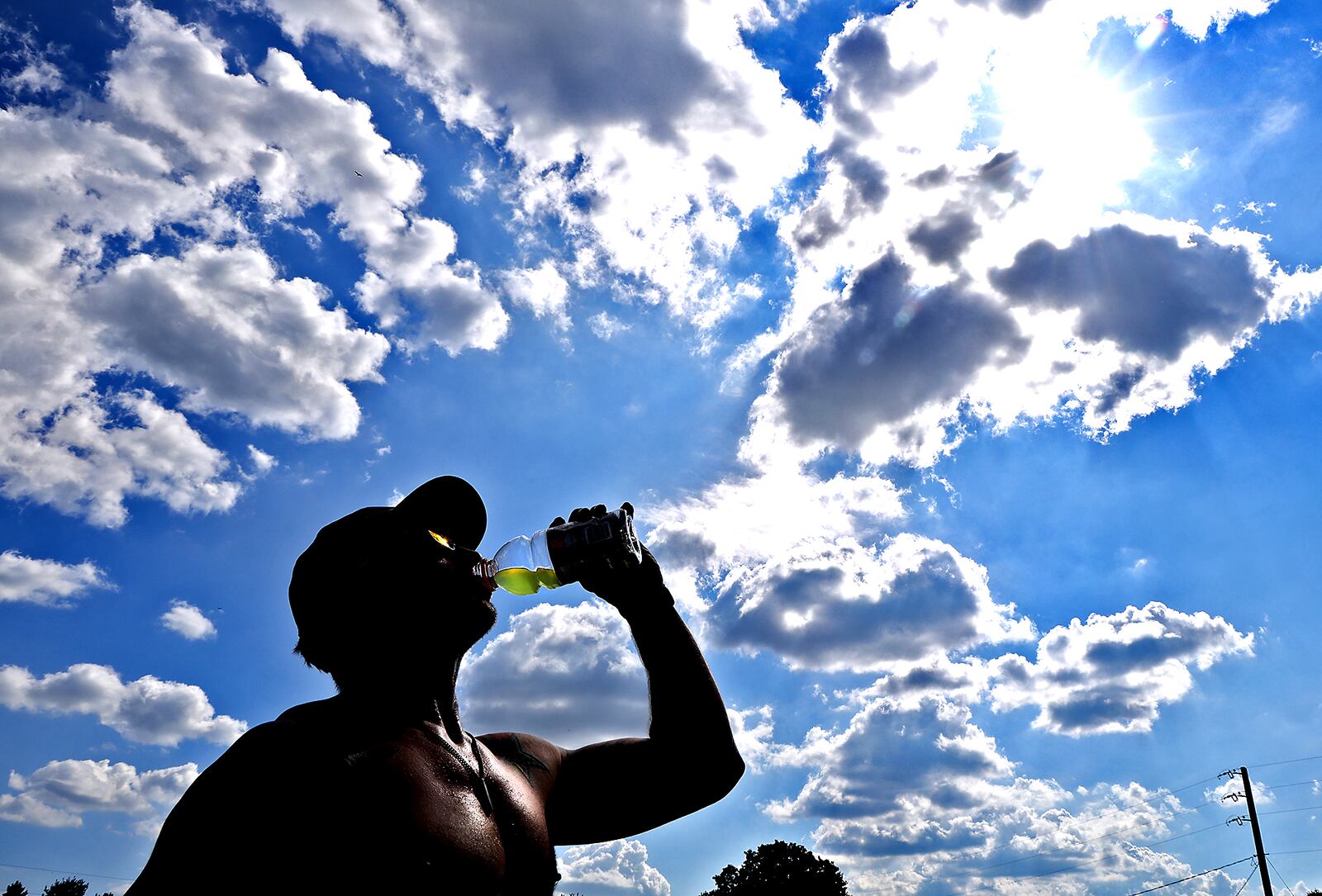 Nate Long, from Urbana, takes a break from running at C.J. Brown Reservior to hydrate Wednesday, August 28, 2024. Long and his friend said they were training for a relay race despite the temperature being in the 90's. BILL LACKEY/STAFF