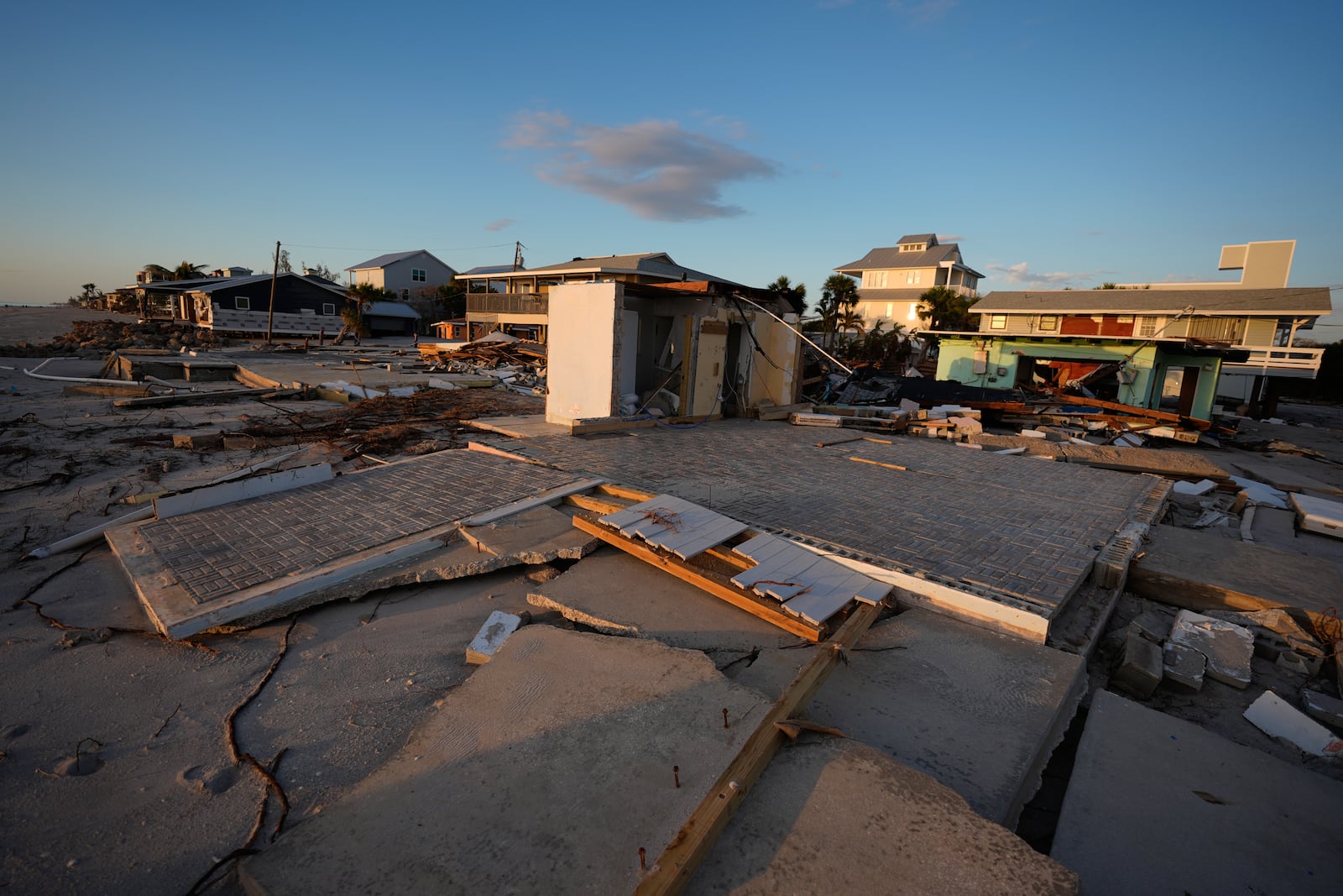 Two beachfront foundations are seen stripped of the buildings that stood on them, after Hurricane Milton, on Manasota Key, Fla., Saturday, Oct. 12, 2024. (AP Photo/Rebecca Blackwell)