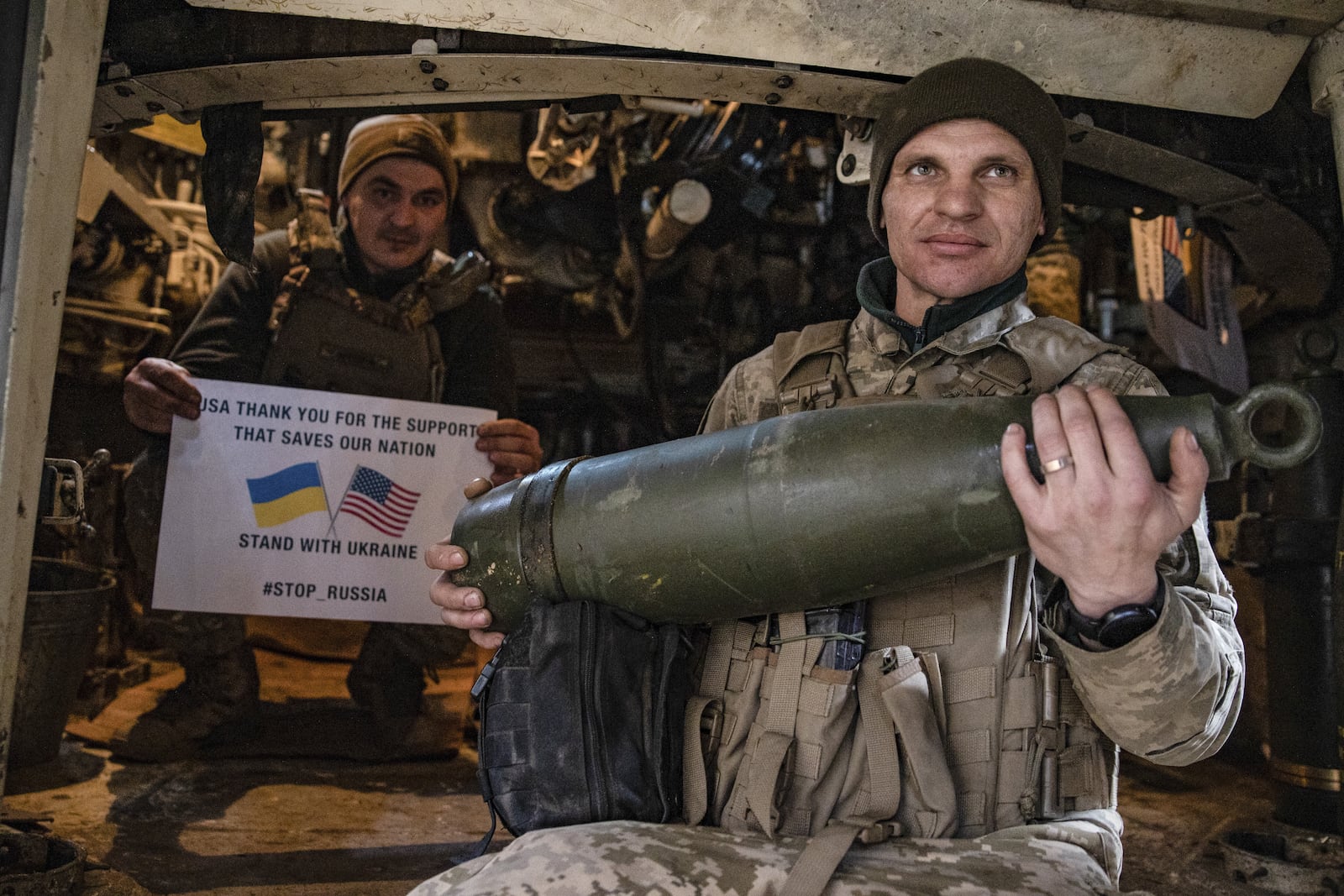 Soldiers of Ukraine's 5th brigade hold a poster thanking for the US for support during a flashmob at the front line near Toretsk, Donetsk region, Ukraine, Tuesday, March 11, 2025. (AP Photo/Roman Chop)