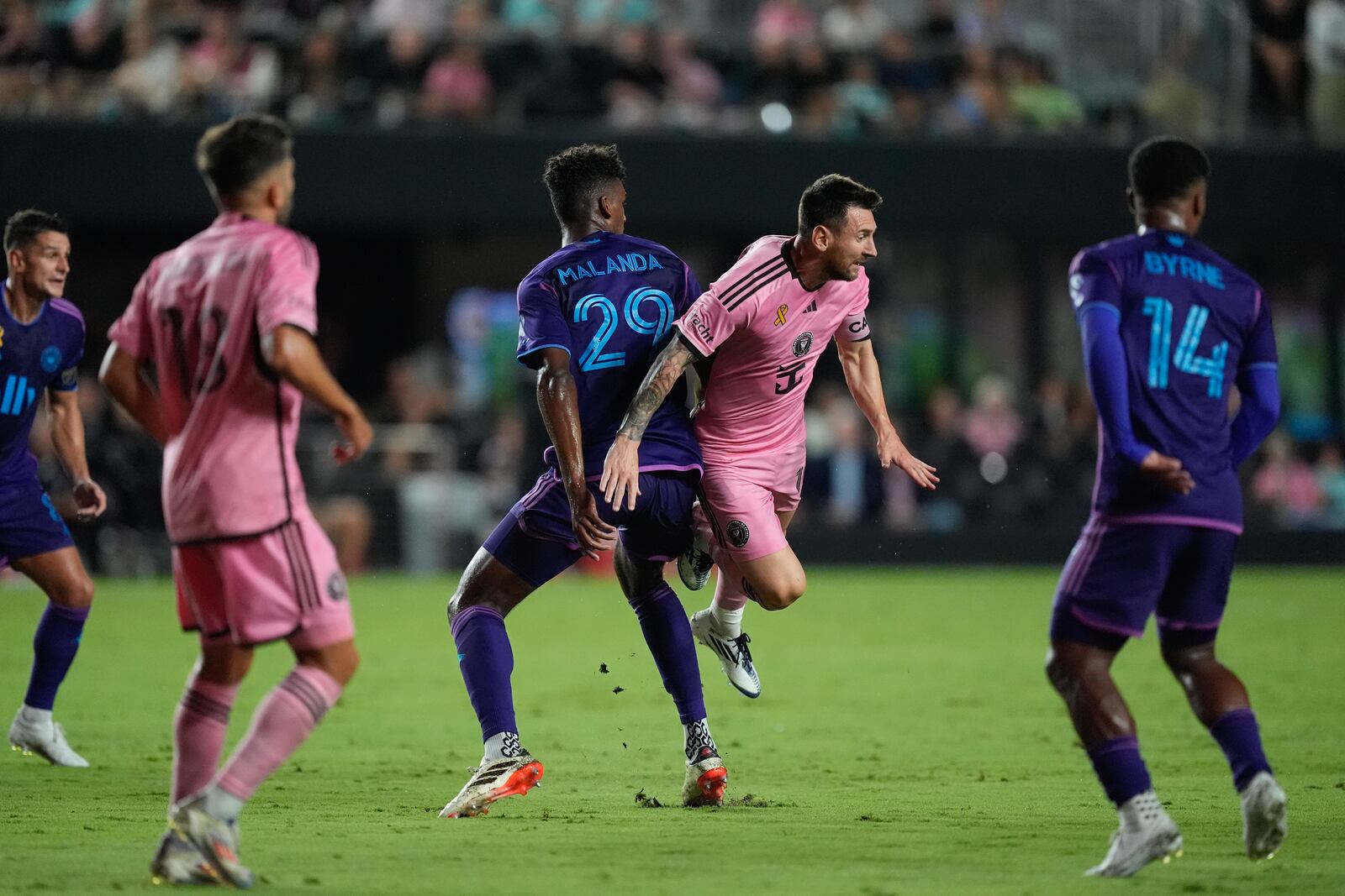 Inter Miami forward Lionel Messi (10) takes a spill as he collides with Charlotte FC defender Adilson Malanda (29) during the first half of an MLS soccer match, Saturday, Sept. 28, 2024, in Fort Lauderdale, Fla. (AP Photo/Rebecca Blackwell)