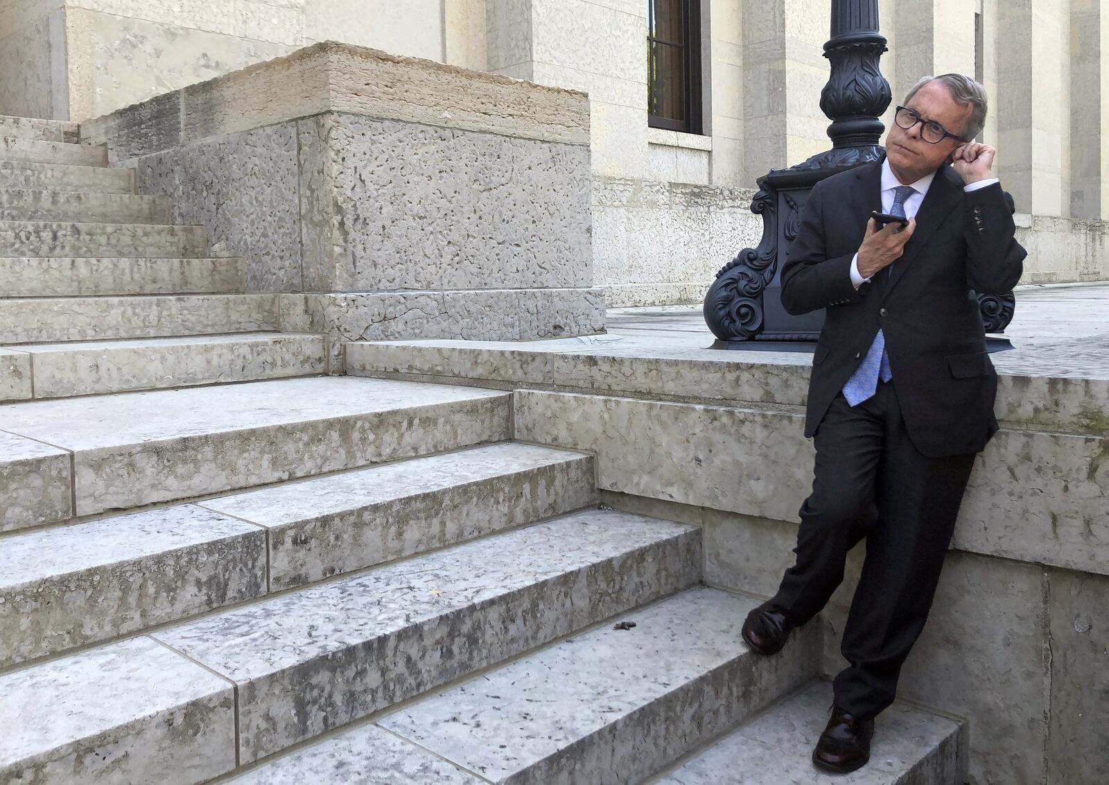 Ohio Gov. Mike DeWine speaks on the cellphone with GM CEO Mary Barra, Wednesday, May 8, 2019, at the Ohio Statehouse in Columbus, about the company’s plans to sell its shuttered factory in Lordstown, Ohio, to a company that builds electric trucks. DeWine, a Republican, said he wanted to hear more details about the plan, including the reaction of the UAW, but said the potential project was better than the plant sitting idle. (AP Photo/Andrew Welsh-Huggins)