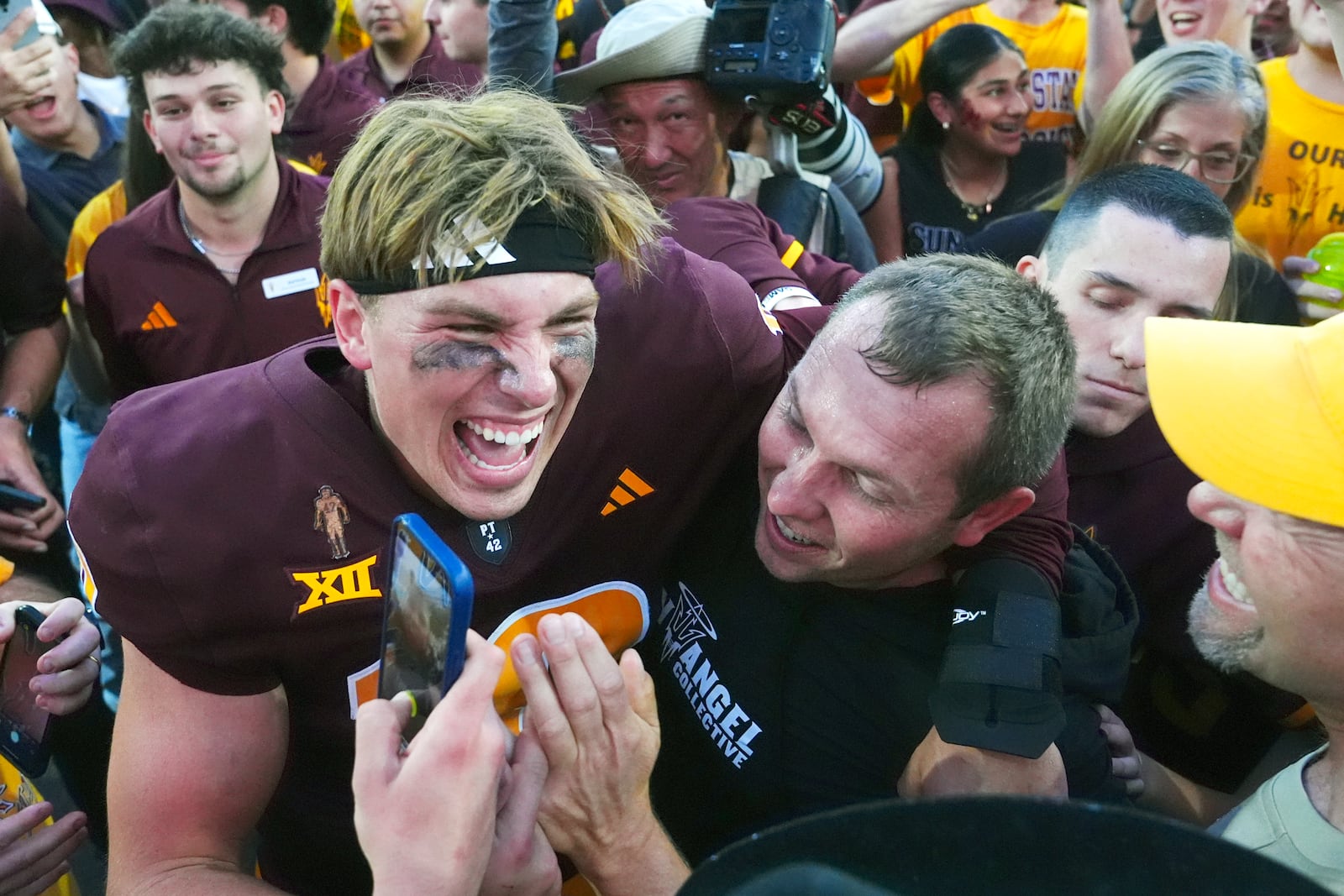 Arizona State quarterback Sam Leavitt, left, celebrates a 28-23. win over BYU with head coach Kenny Dillingham, right, after an NCAA college football game Saturday, Nov. 23, 2024, in Tempe, Ariz. (AP Photo/Ross D. Franklin)