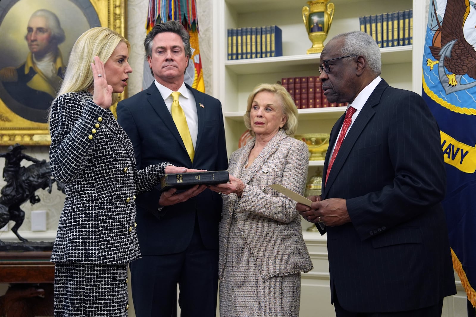 Pam Bondi is sworn in as Attorney General by Supreme Court Associate Justice Clarence Thomas, right, as partner John Wakefield and mother Patsy Bondi look on, in the Oval Office of the White House, Wednesday, Feb. 5, 2025, in Washington. (AP Photo/Evan Vucci)