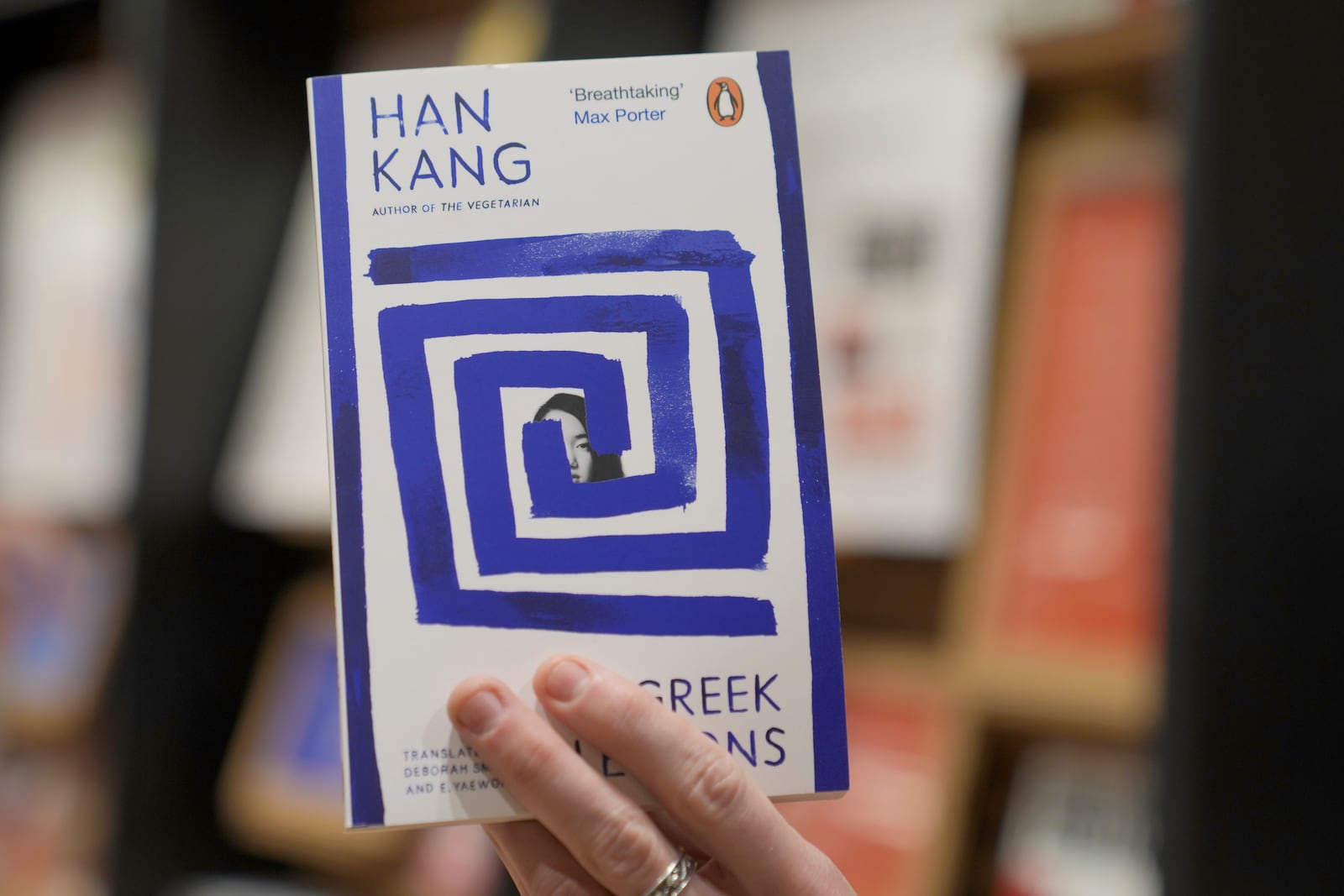 A book store employee holds a book by the South Korean writer Han Kang in London, Thursday, Oct. 10, 2024. Kang has been awarded the Nobel Prize for Literature. (AP Photo/Kin Cheung)