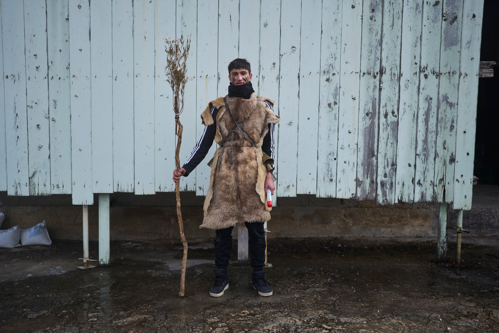 Vlasis Bellos, 19, poses for a portrait, dressed in animal skins and heavy bronze bells, as part of carnival celebrations in Distomo, a village in central Greece, on Monday, March 3, 2025. (AP Photo/Petros Giannakouris)