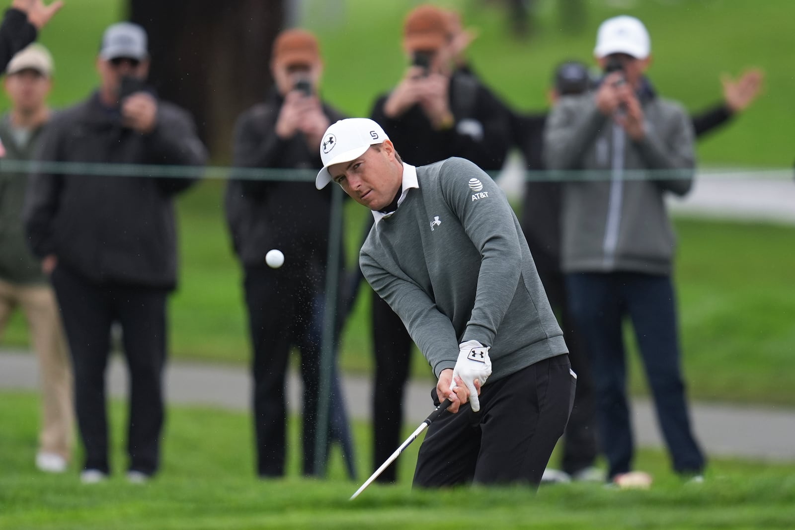 Jordan Spieth chips on the sixth green of the South Course at Torrey Pines during the first round of the Genesis Invitational golf tournament Thursday, Feb. 13, 2025, in San Diego. (AP Photo/Gregory Bull)