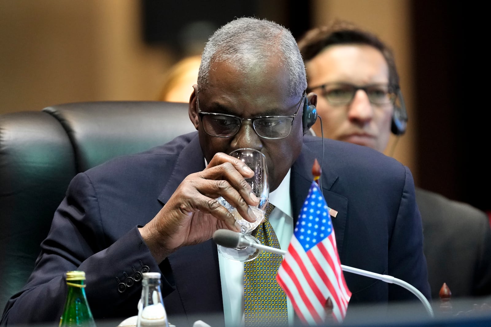 US Defense Secretary Lloyd Austin drinks water during the Association of Southeast Asian Nations (ASEAN) defense ministers' meeting in Vientiane, Laos, Thursday, Nov. 21, 2024. (AP Photo/Anupam Nath)